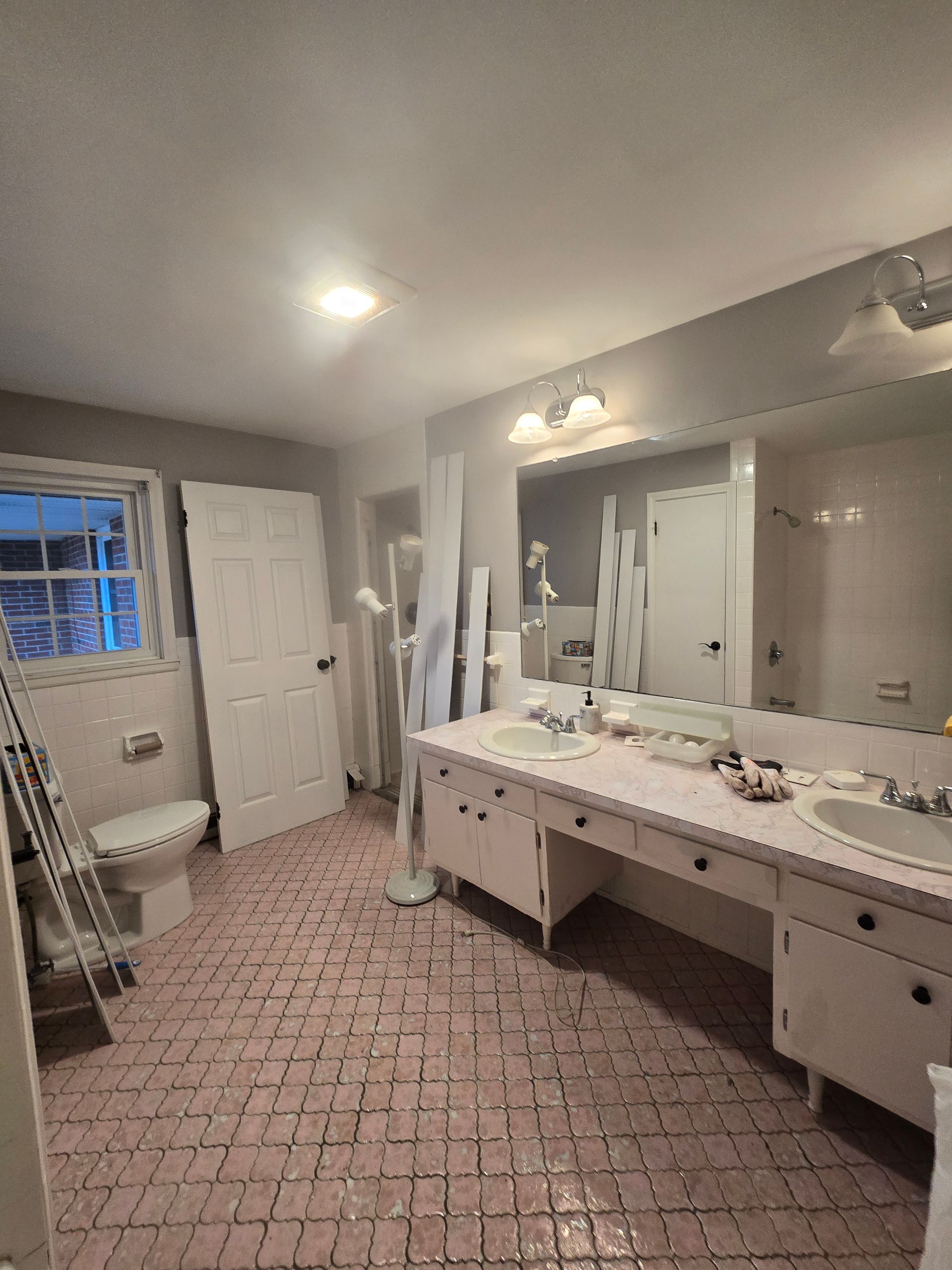 A bathroom with a walk in shower and a shower head