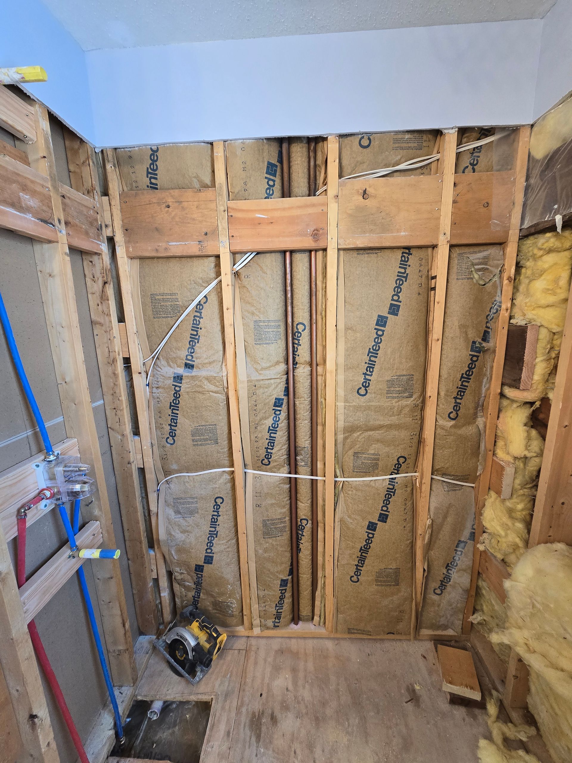 A bathroom with a bathtub and a shower head