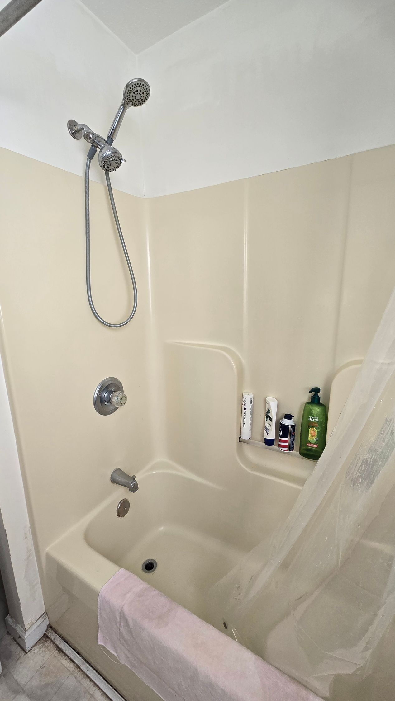 A bathroom with a bathtub and a shower.