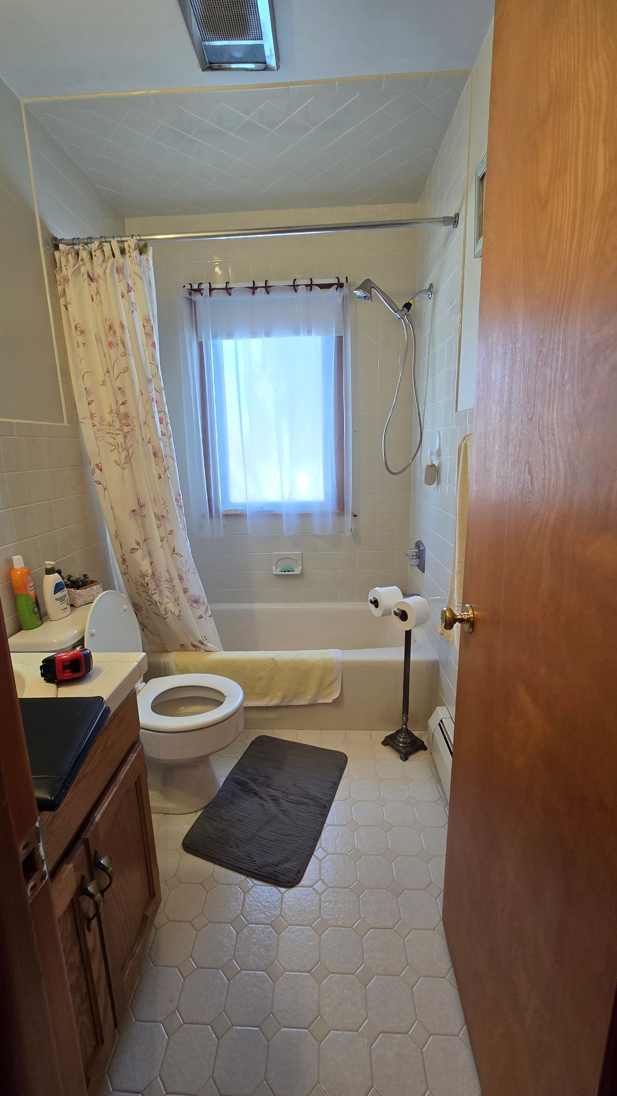 A bathroom with a bathtub and a shower head