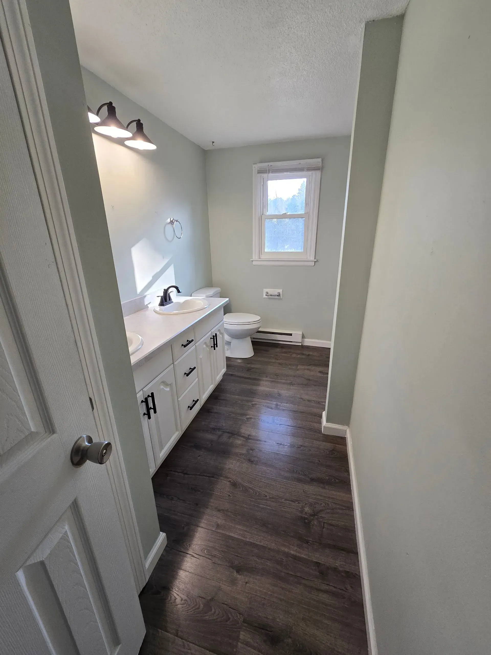 A before and after photo of a bathroom remodel.