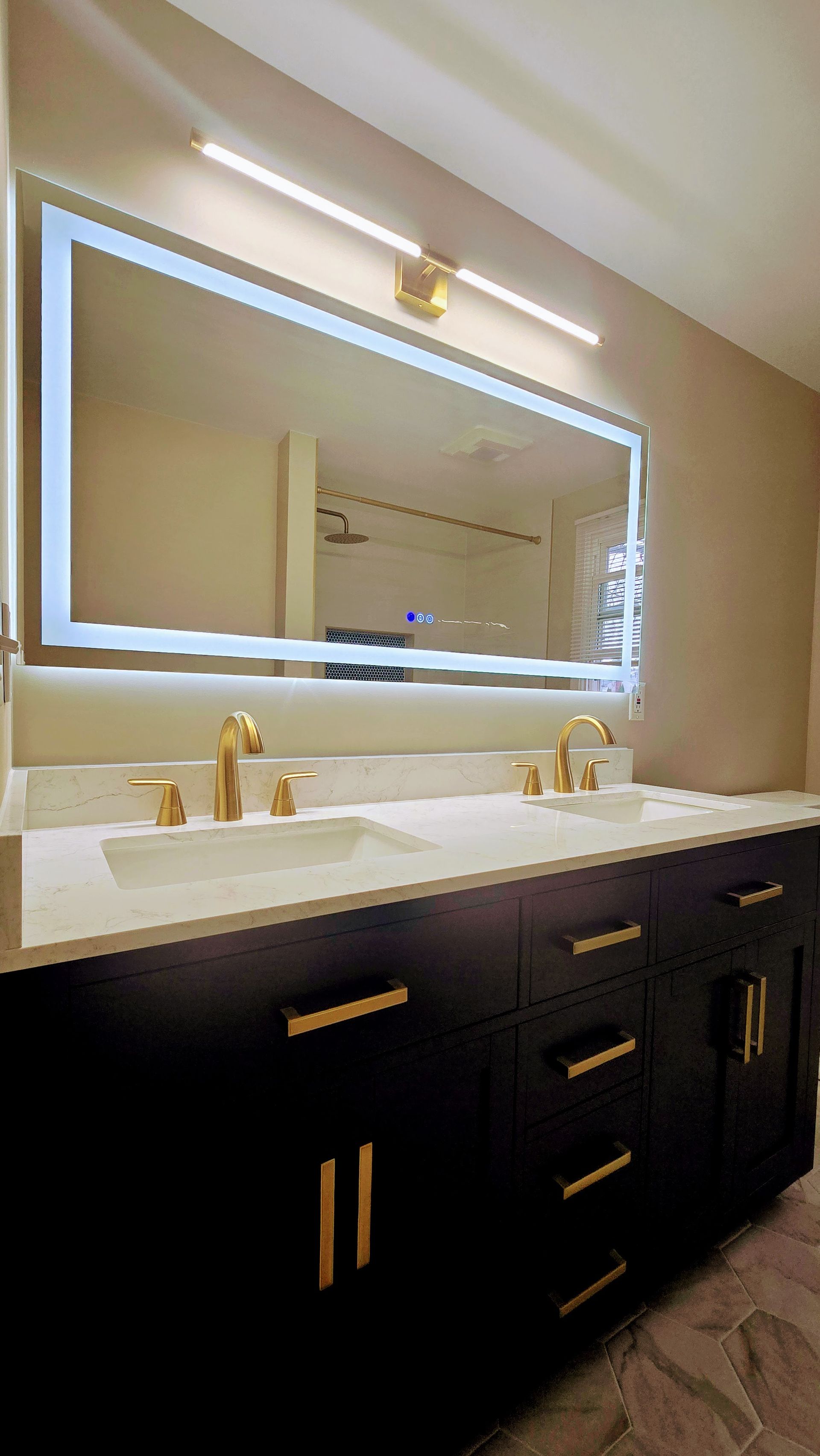 A bathroom with a sink , mirror and cabinets.