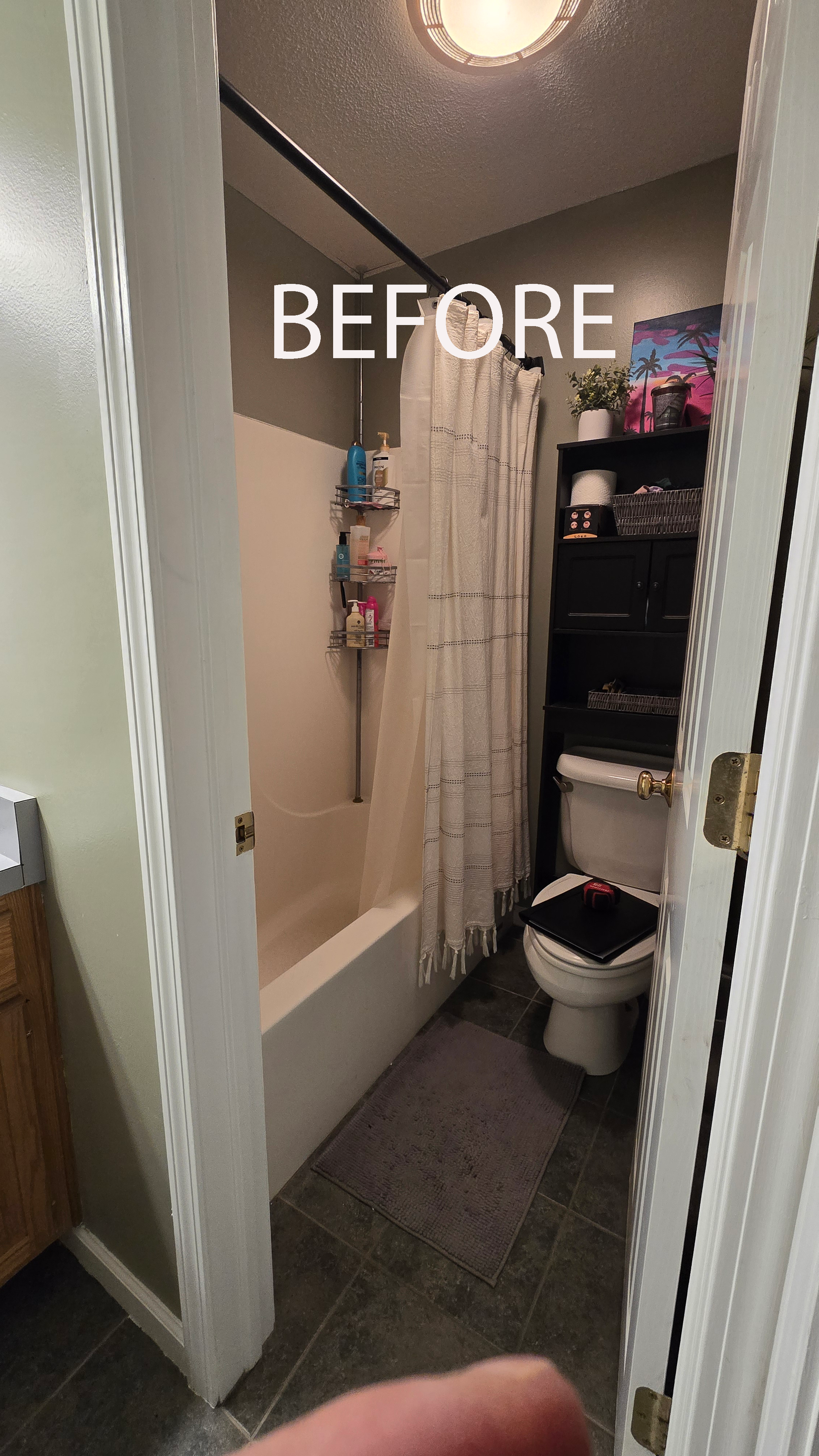 Bathroom with vanity, tub, and window. Gray tile floor, wood cabinets, and brown curtains.