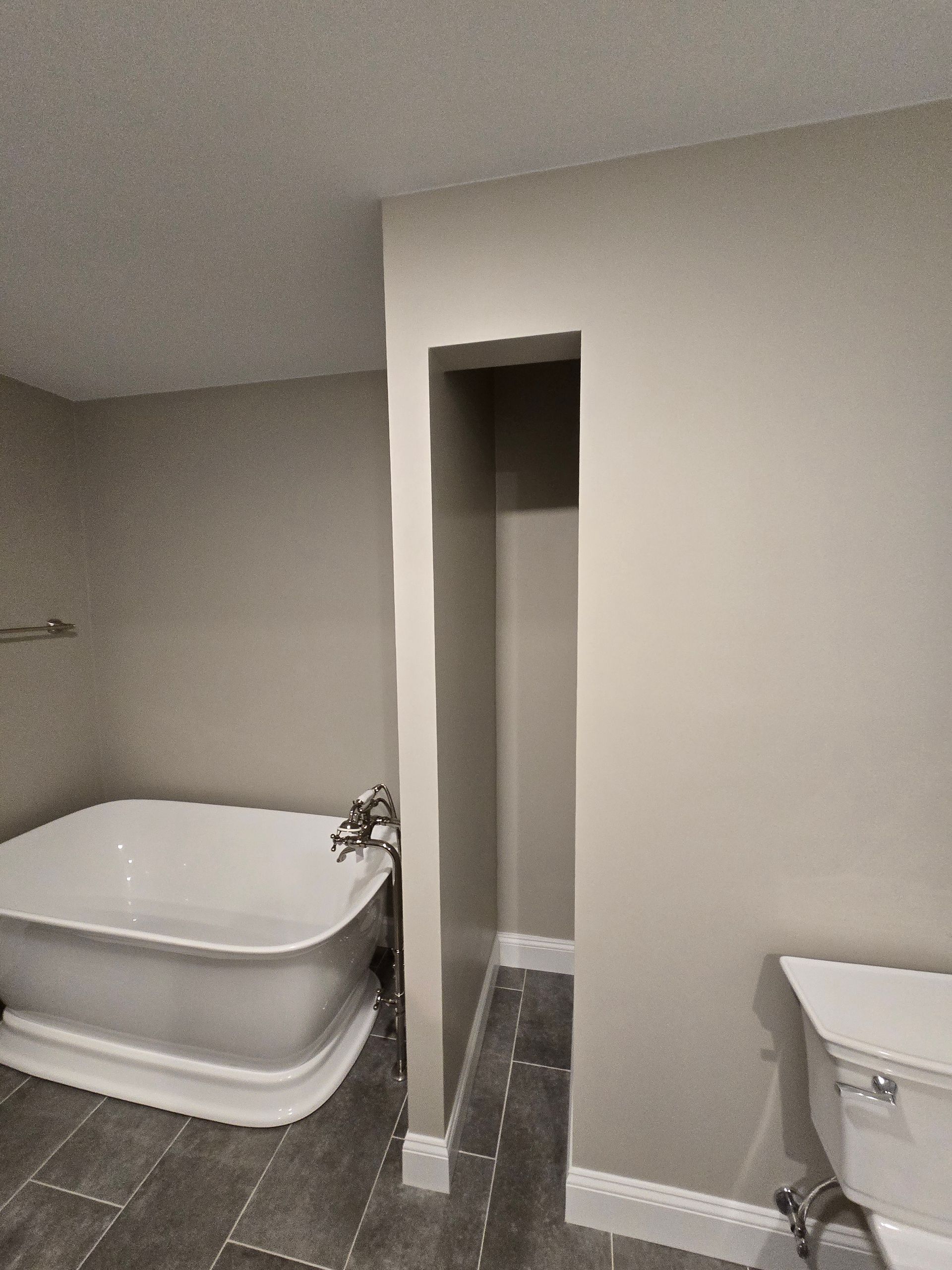 A shower with a built in shelf and a shower head