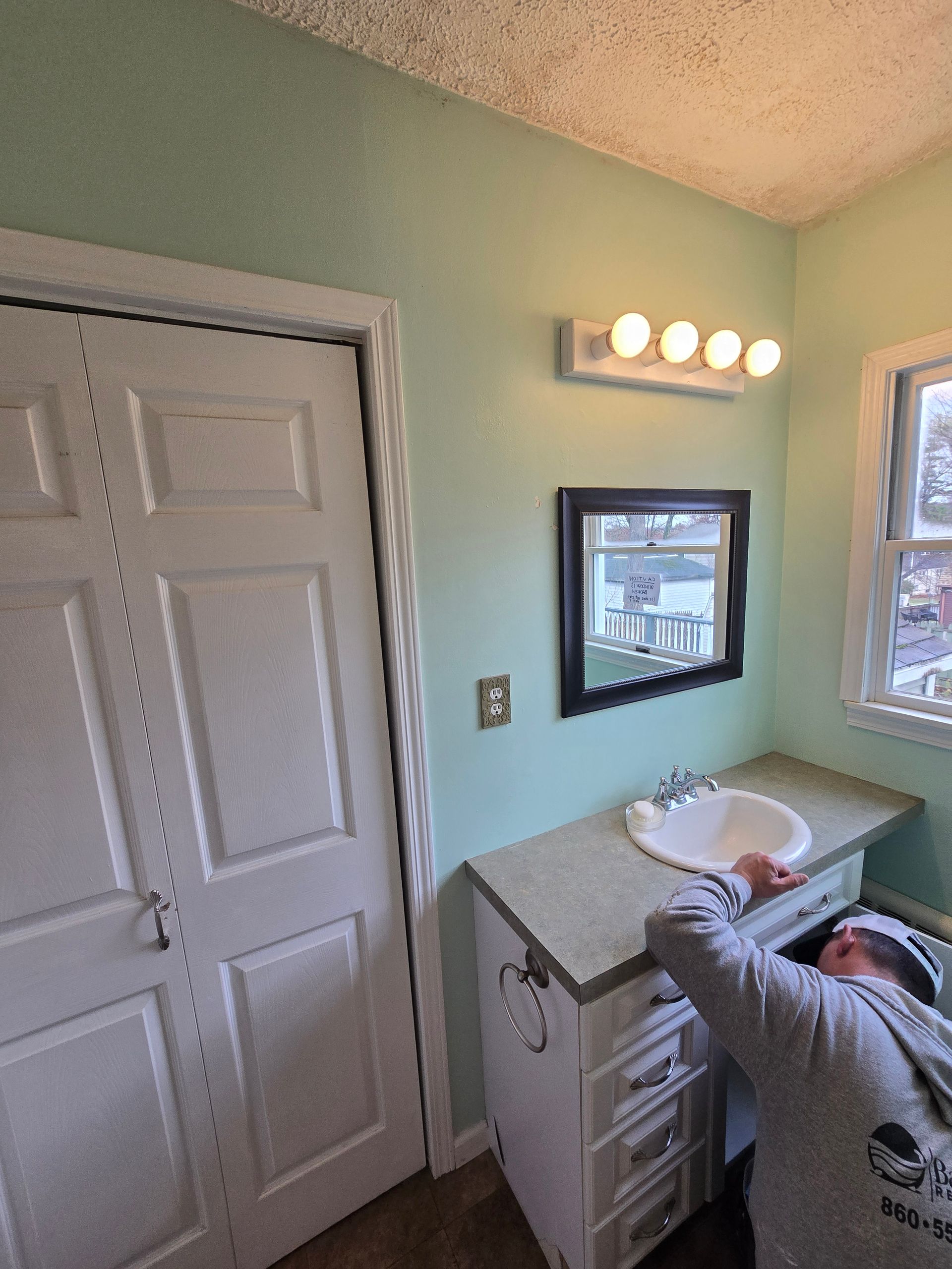 A bathroom with a bathtub and a shower head