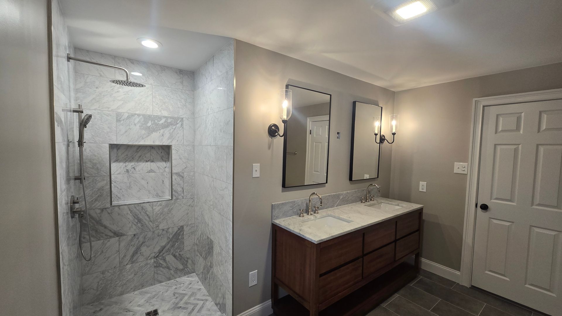 A shower with a bench and a shower head