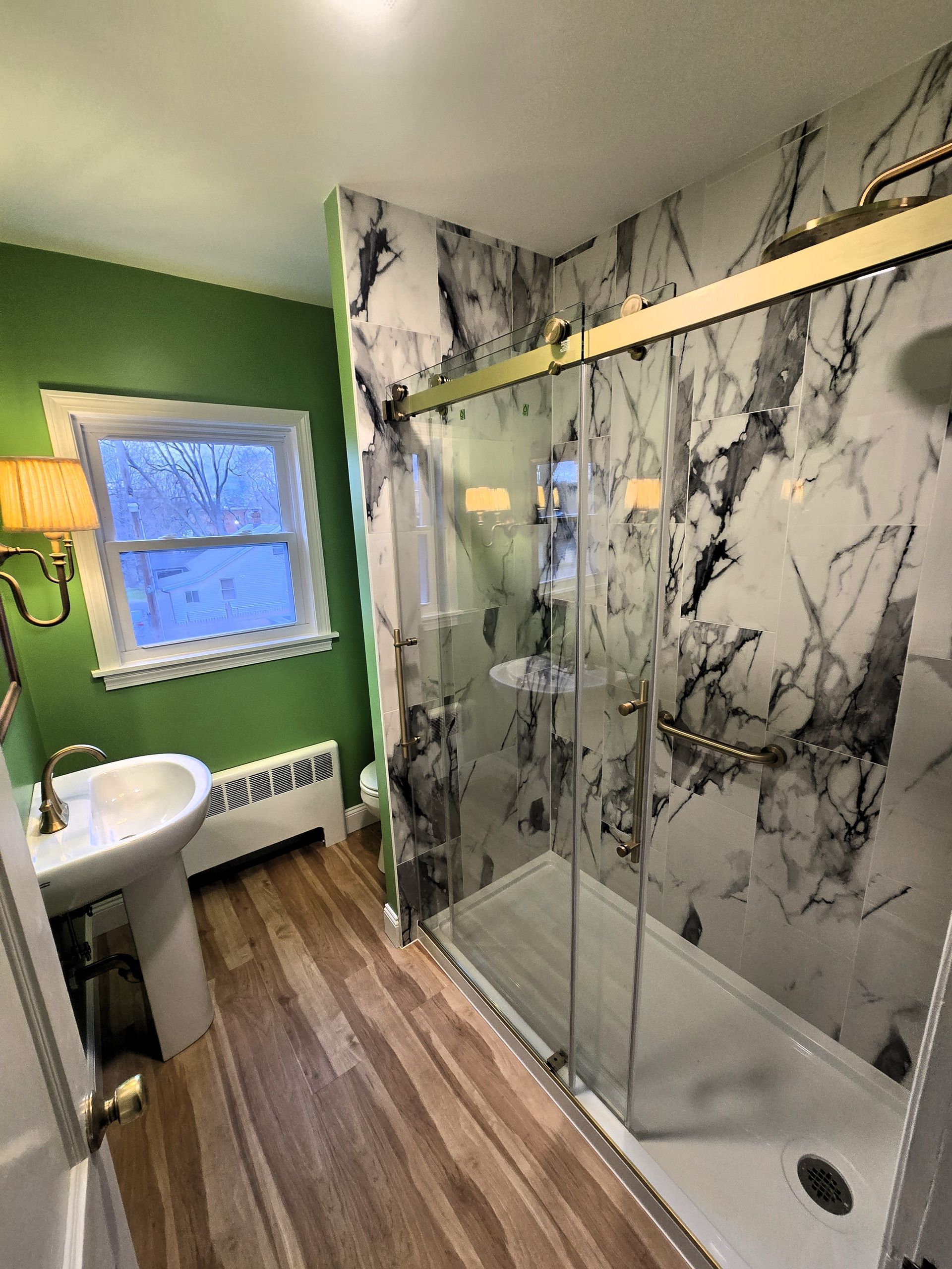 A bathroom with a bathtub and a shower head