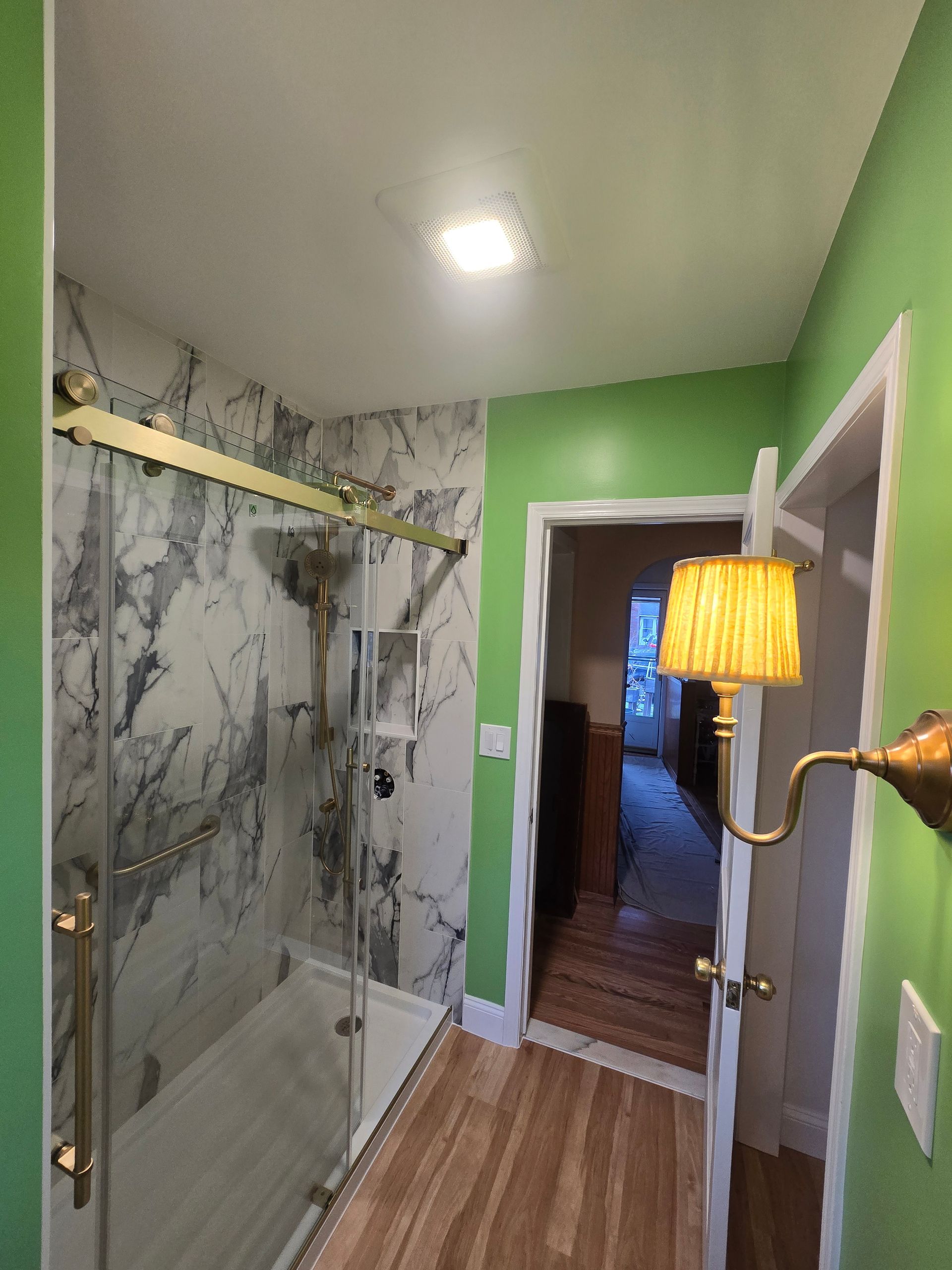 A bathroom with a bathtub and a shower head