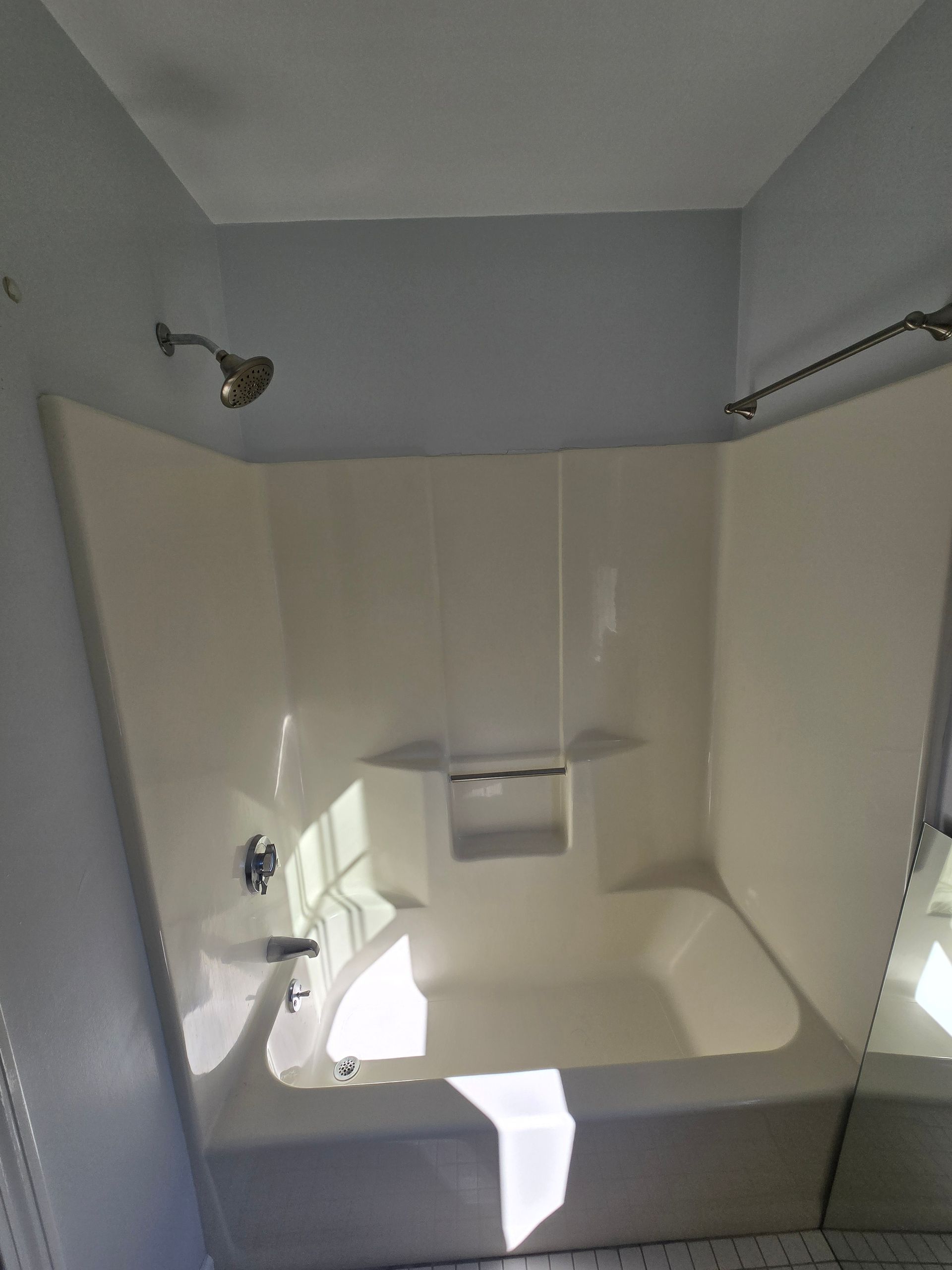 A bathroom under construction with a toilet , sink and window.