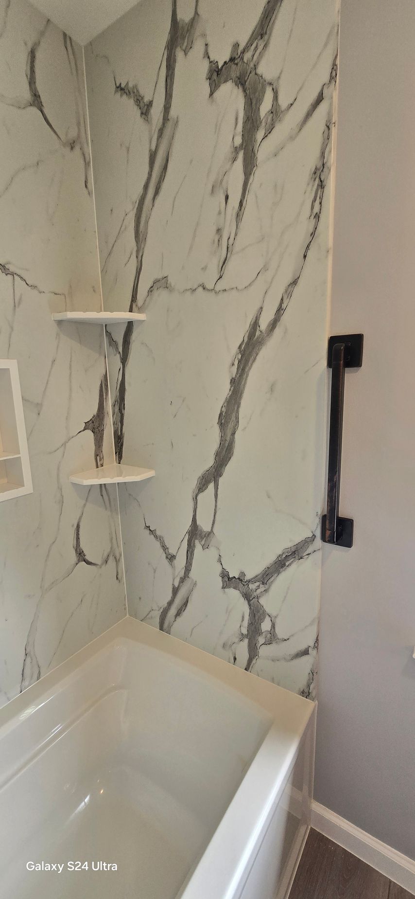 A bathroom with a bathtub and toilet.