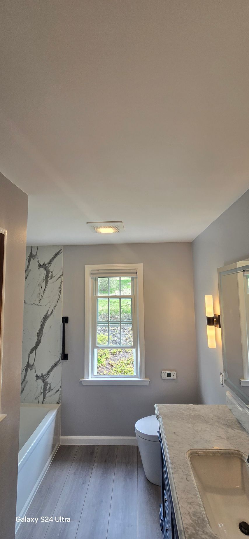 A white bathtub with a faucet in a bathroom.