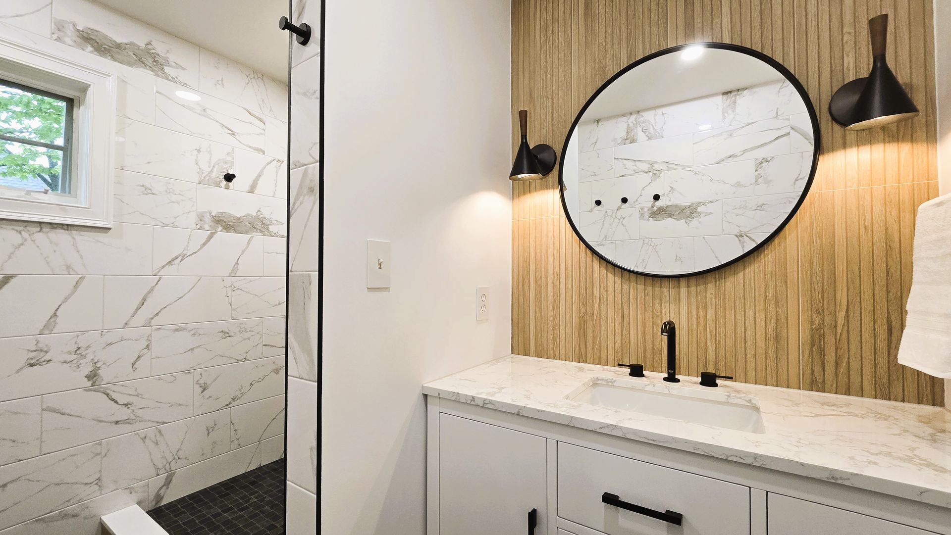 A bathroom with a sink , mirror and towel rack.