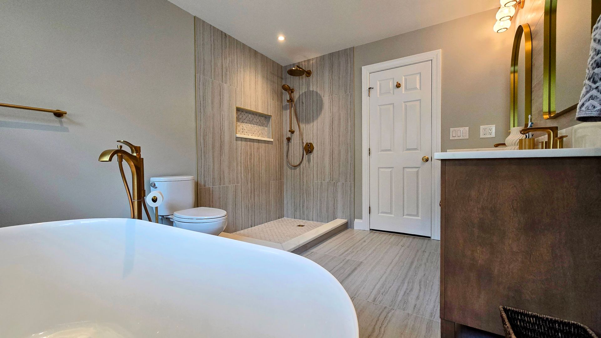 A bathroom with a bathtub , toilet , sink and shower.