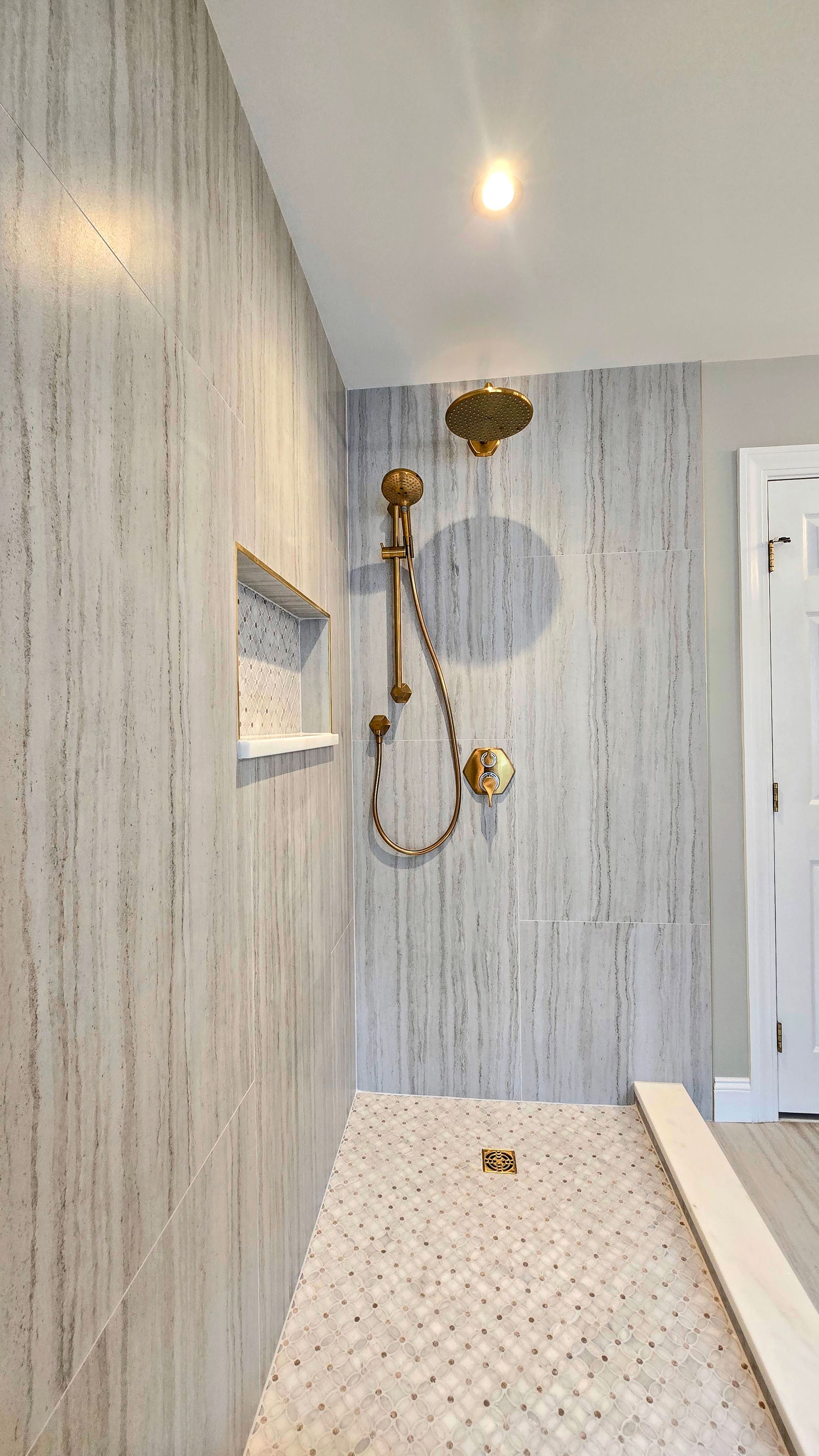 A bathroom remodel in Cheshire, CT with a tub , sink , mirror and window.