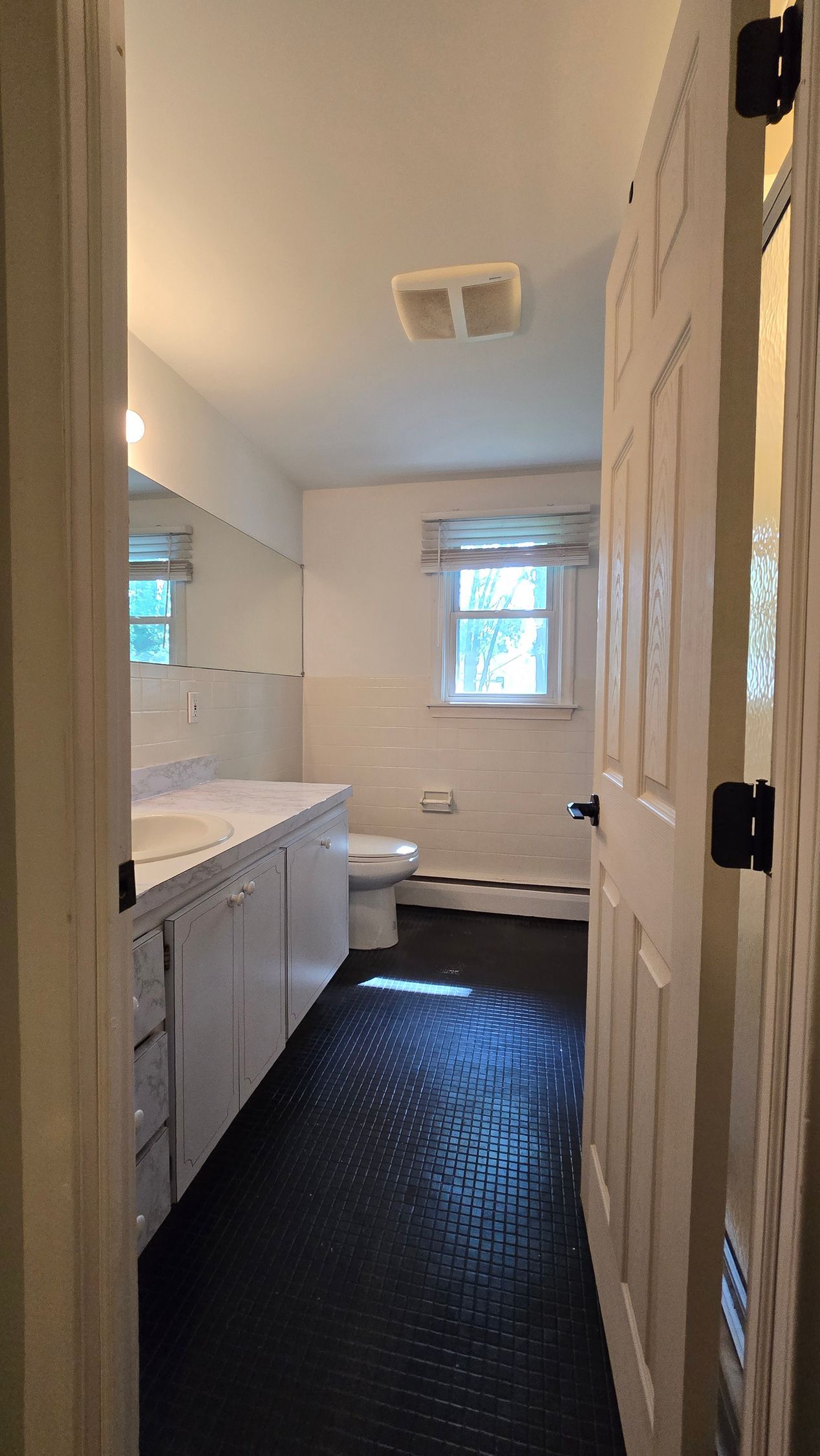 A bathroom with a walk in shower and a shower head