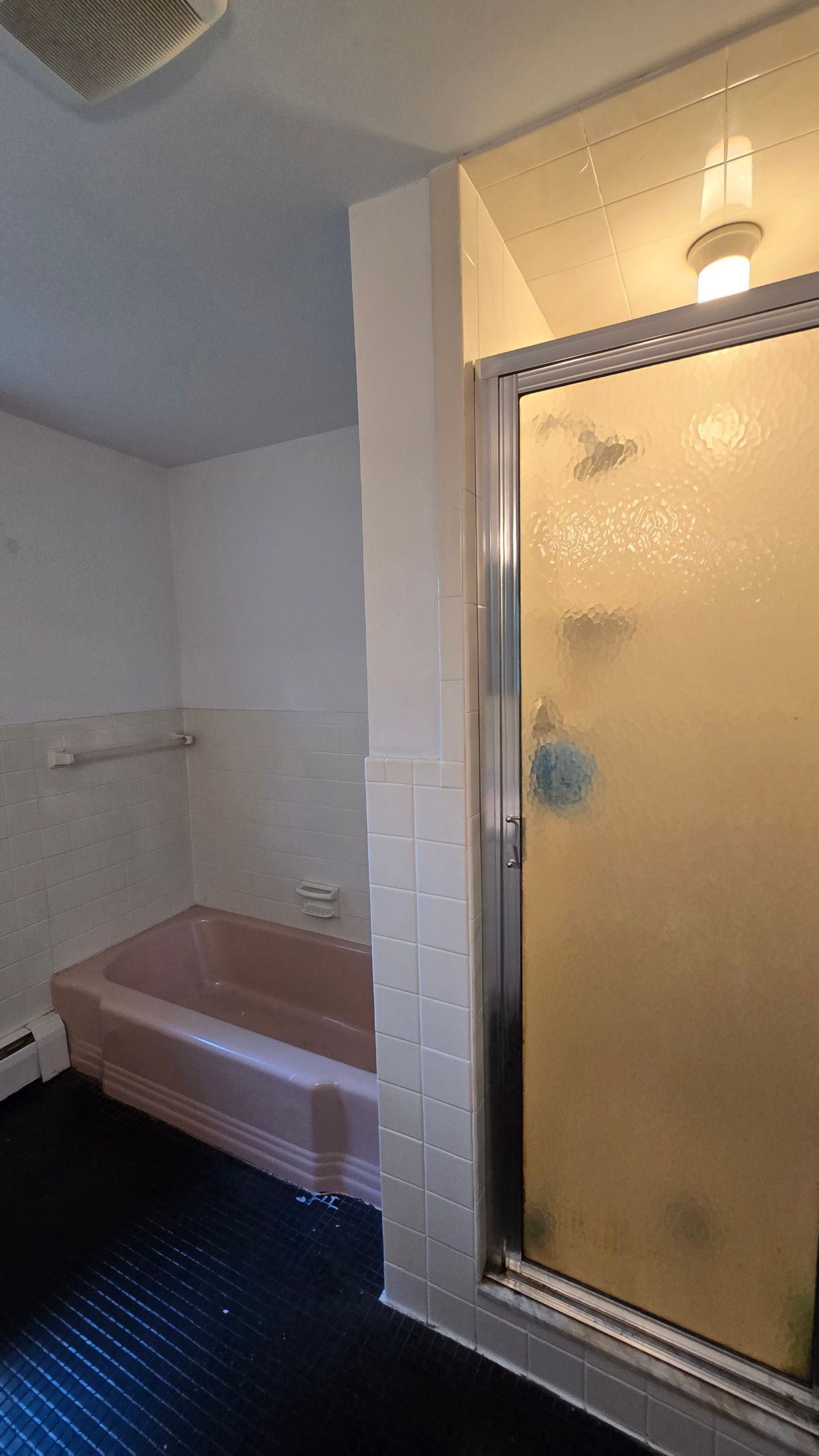 A shower with a built in shelf and a shower head