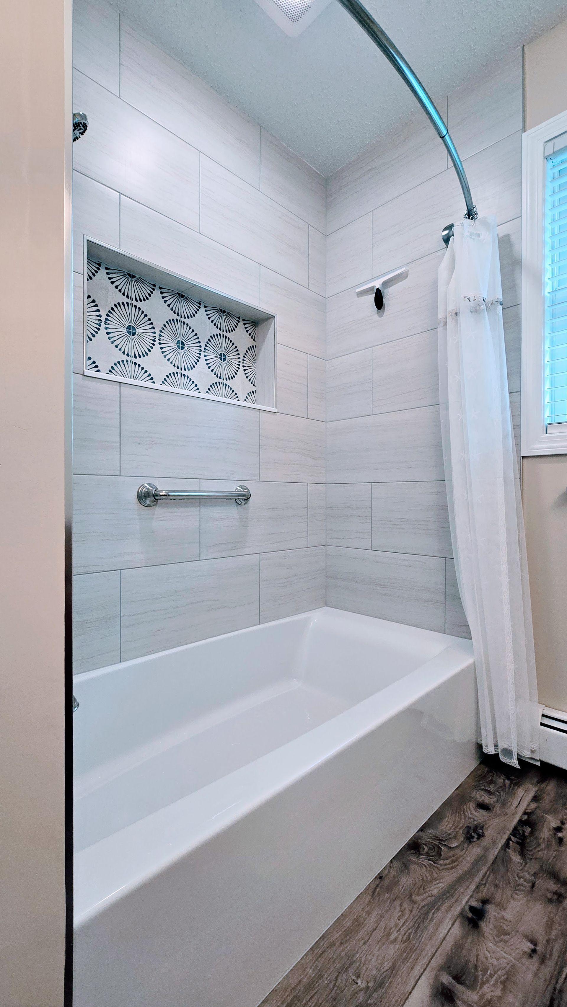 A bathroom with a bathtub and a shower.