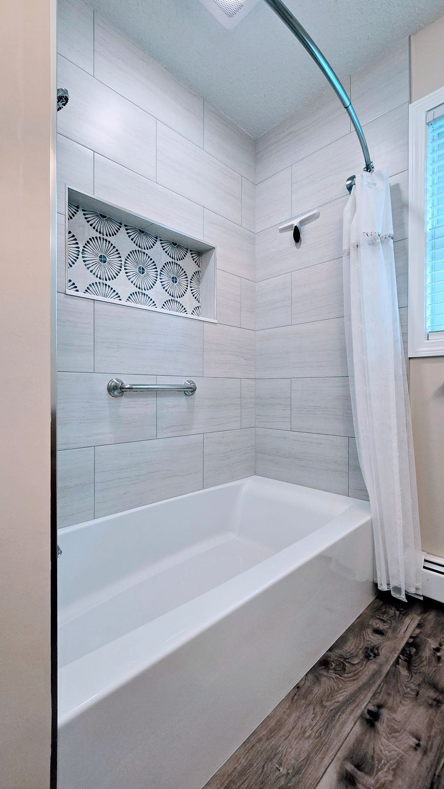 A bathroom with a bathtub and a shower.
