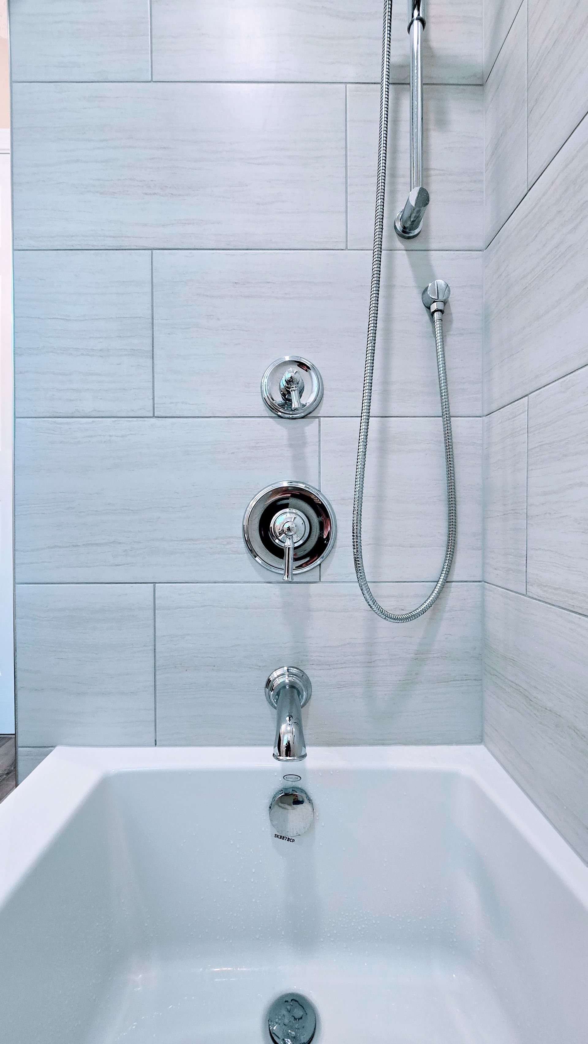 A bathtub with a shower head attached to it in a bathroom.
