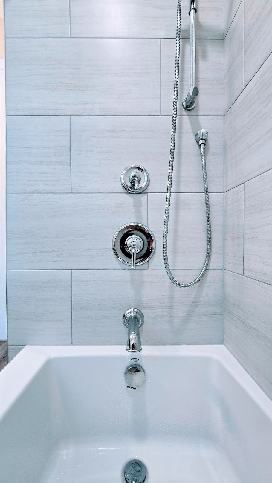 A bathtub with a shower head attached to it in a bathroom.