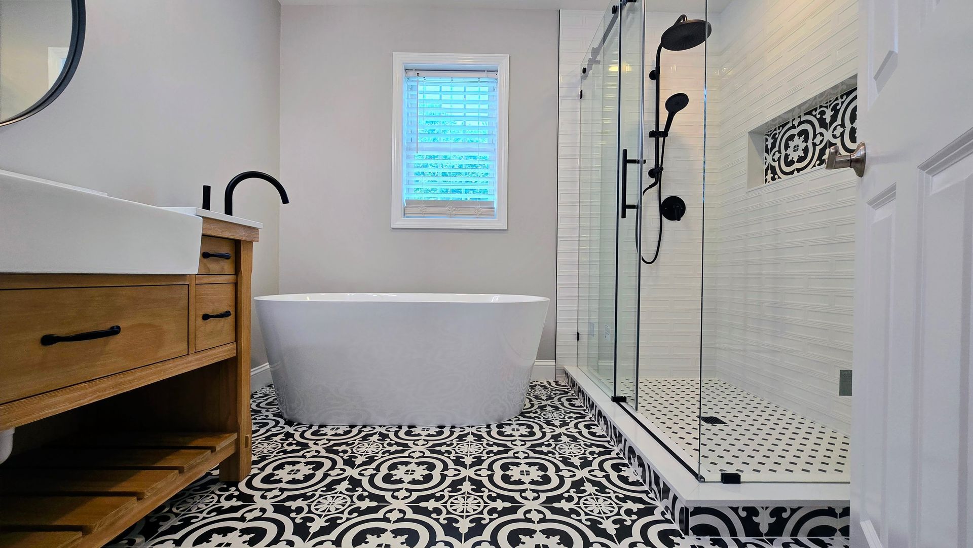 A bathroom with a tub , sink , and shower.