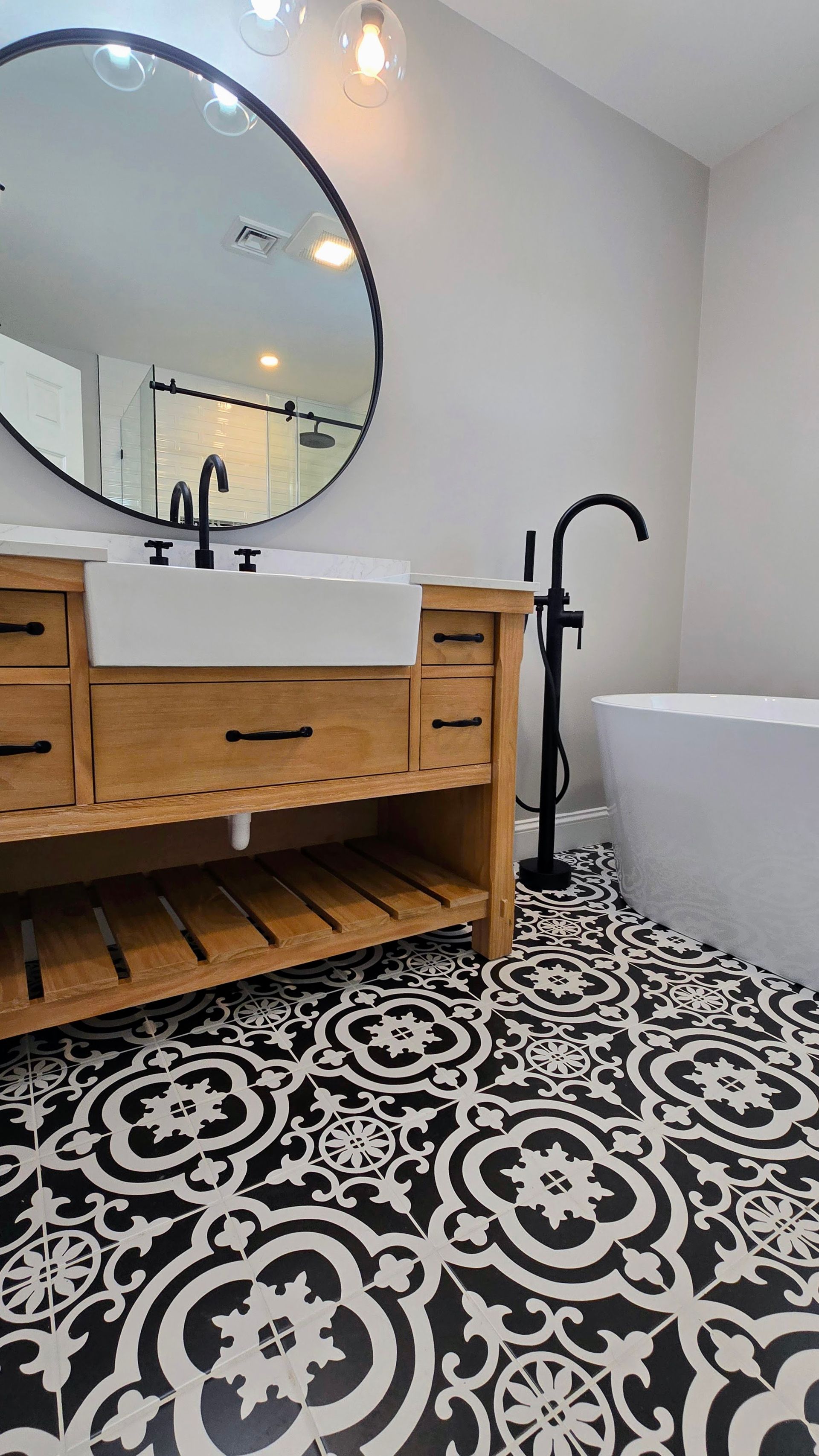 A bathroom remodel in Southington, CT with a bathtub , sink , mirror and television.
