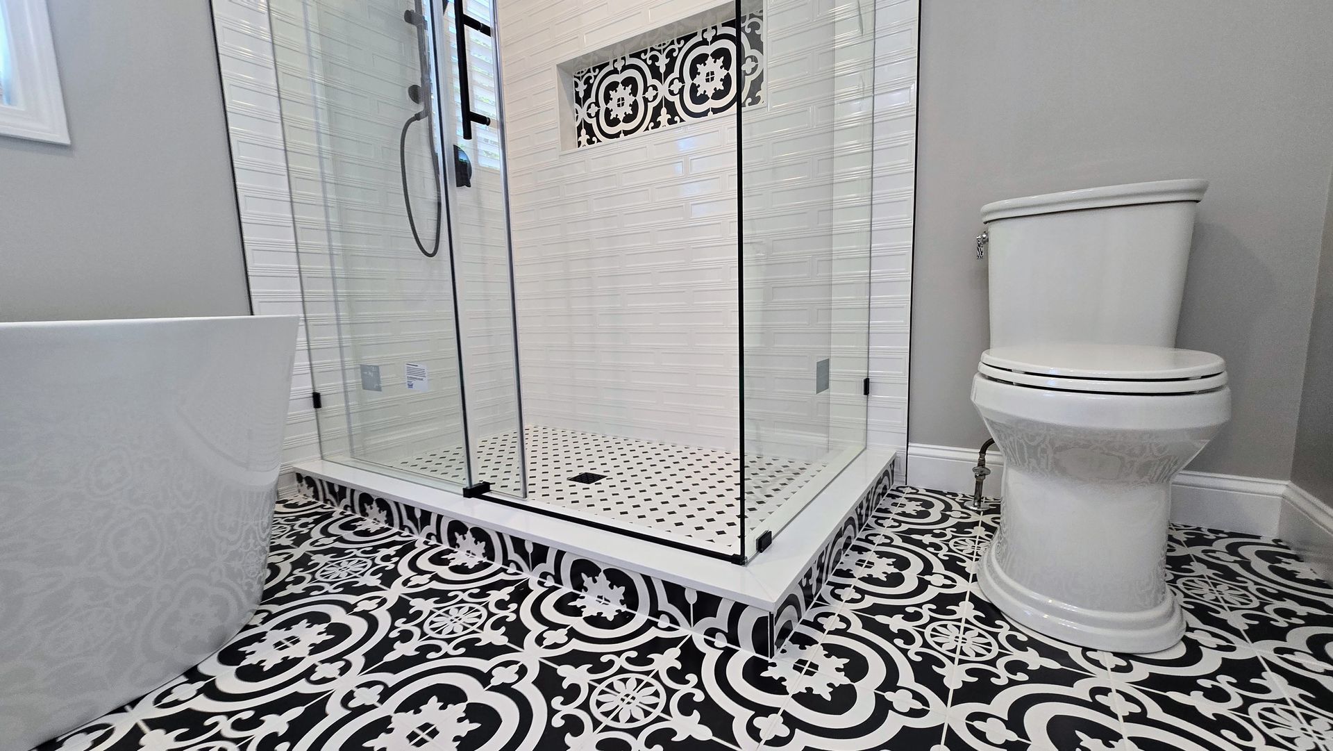 A bathroom with a jacuzzi tub , sink , mirror and television.