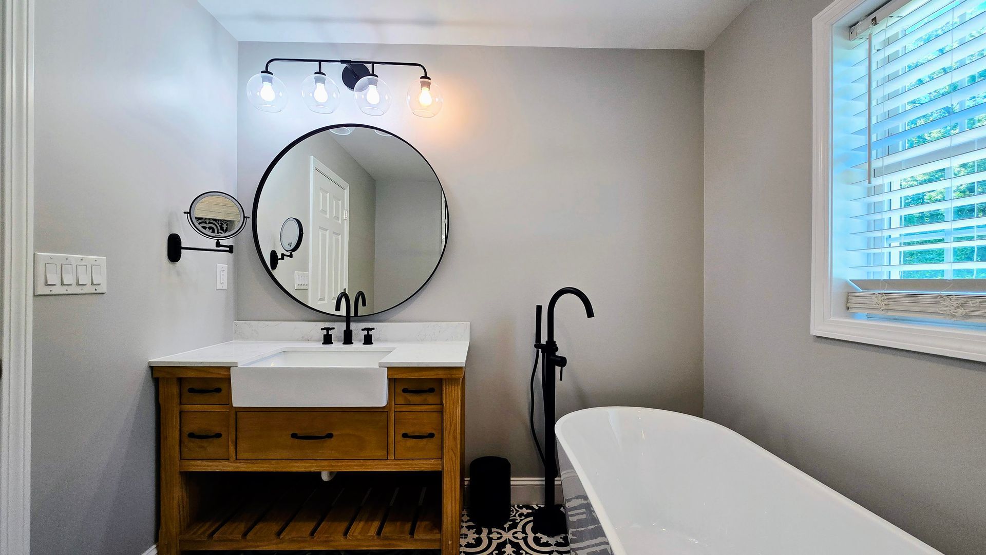 A bathroom with a bathtub and a shower head