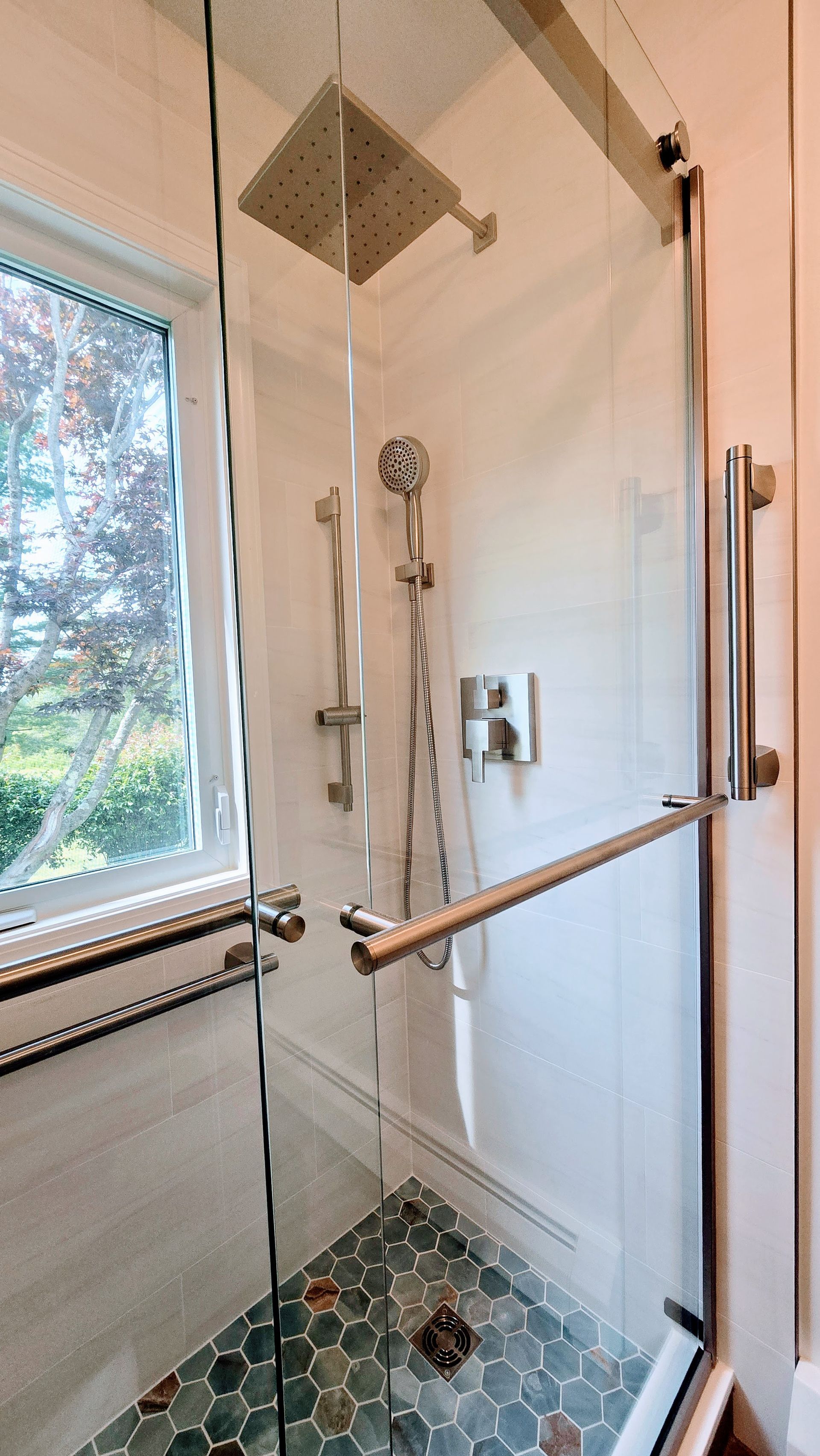 A bathroom with a bathtub and a shower head