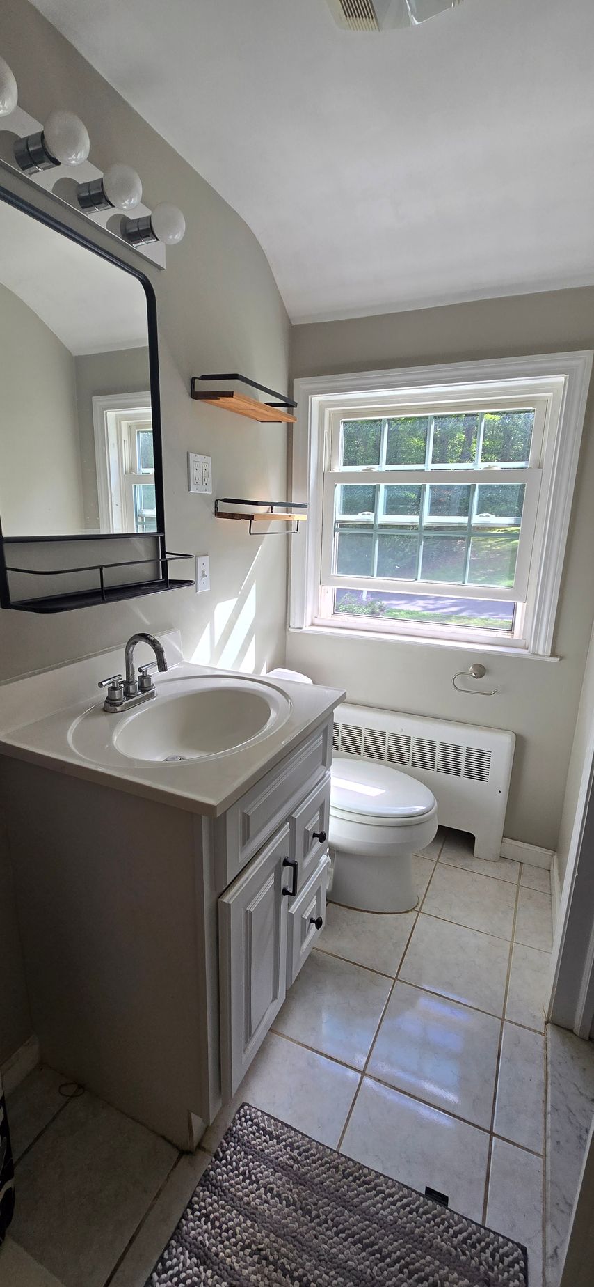 A bathroom with a bathtub and a shower head