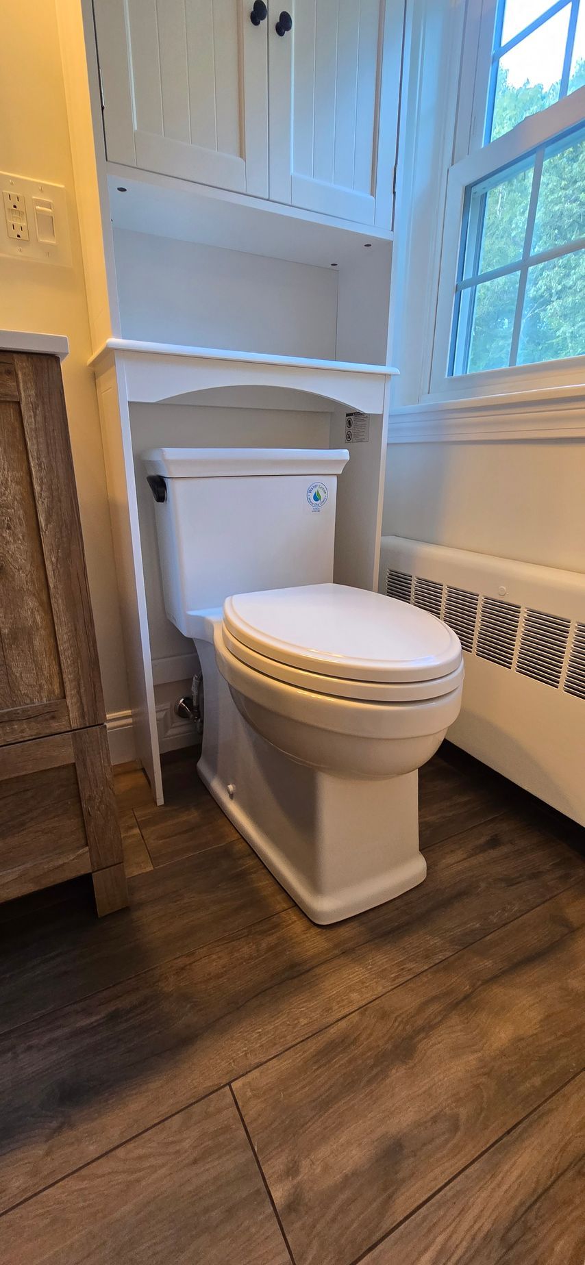 A shower with a bench and a shower head
