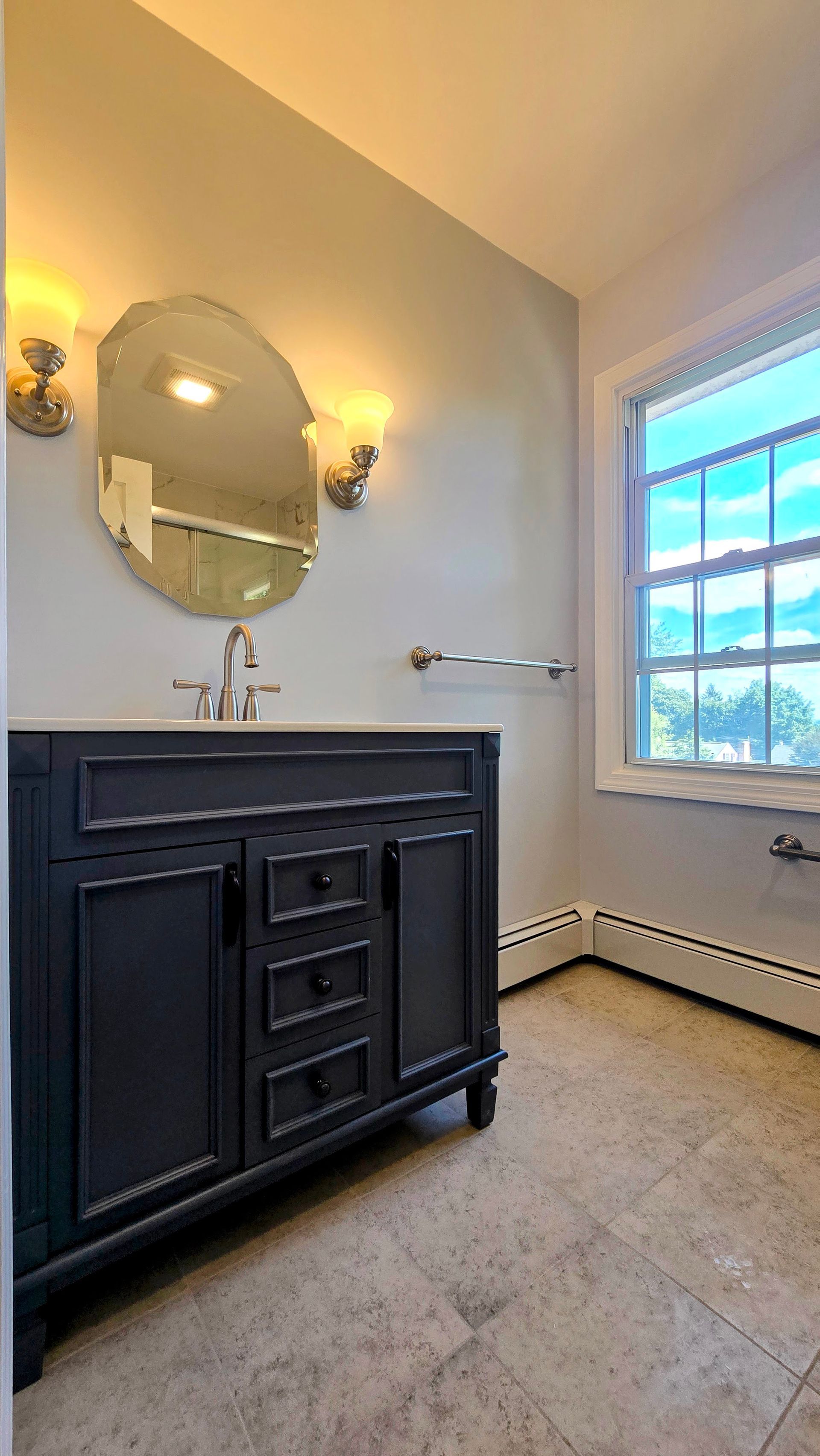 Modern Bristol bathroom vanity with a lighted mirror and black faucets.