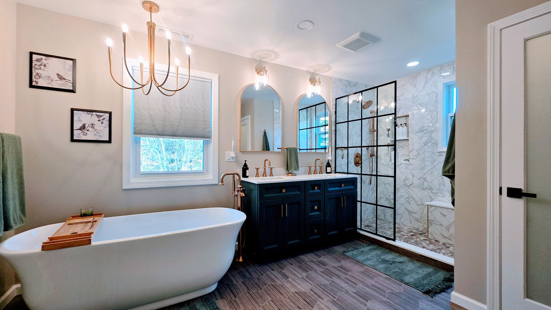 Bathroom with jacuzzi tub, vanity, toilet. Light beige walls, brown cabinets, glass shower door.