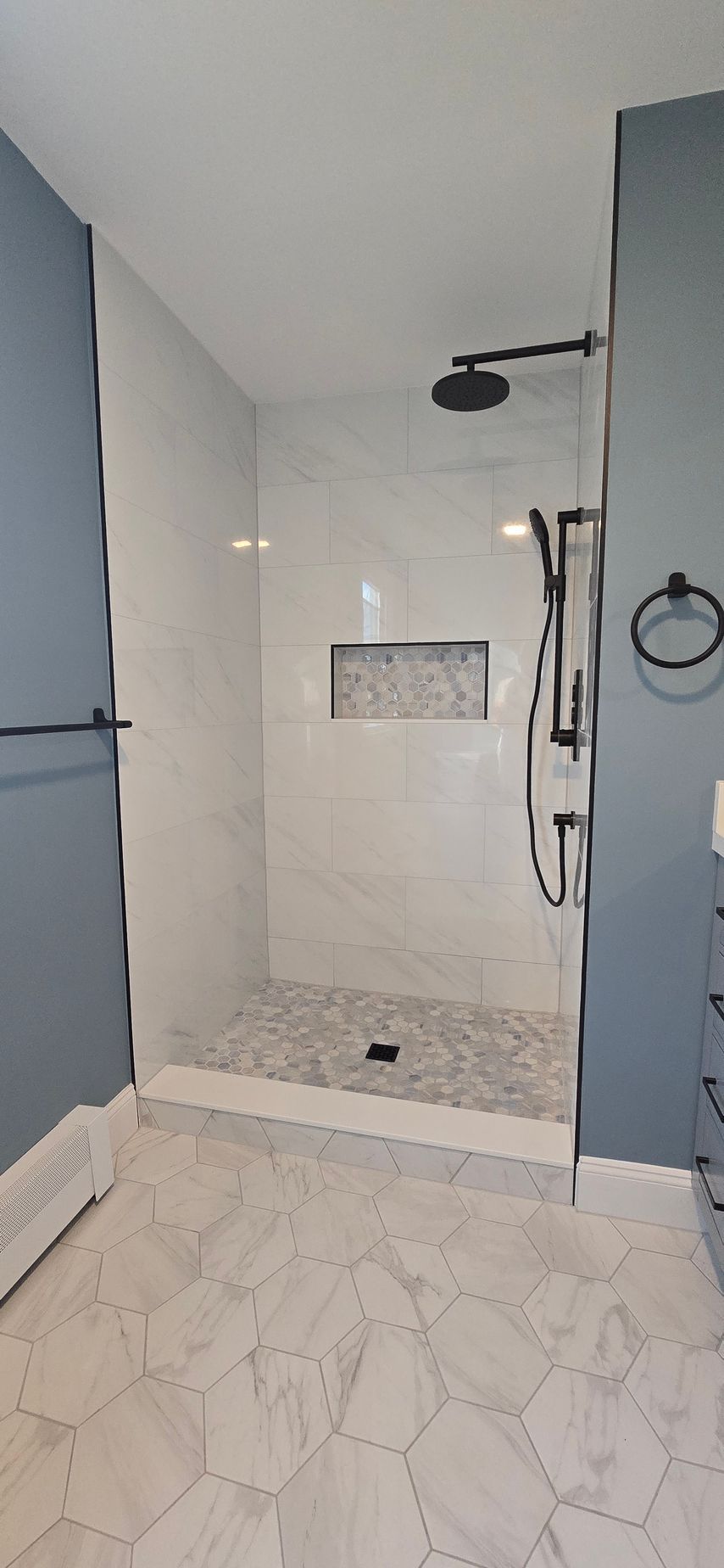 Bristol bathroom vanity with black fixtures, lit mirror, and neutral walls.
