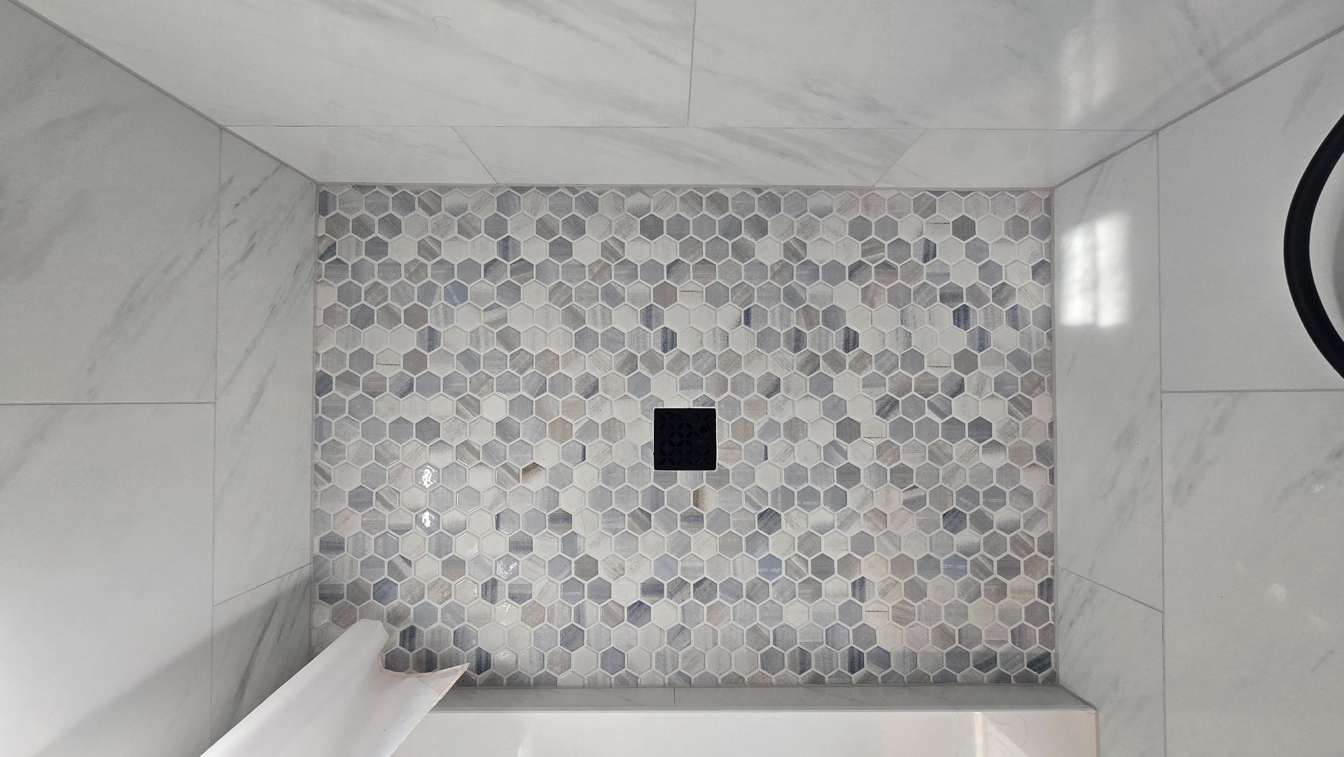 Bathroom in Wethersfield, CT with jacuzzi tub, vanity, toilet. Light beige walls, brown cabinets, glass shower door in Wolcott, CT