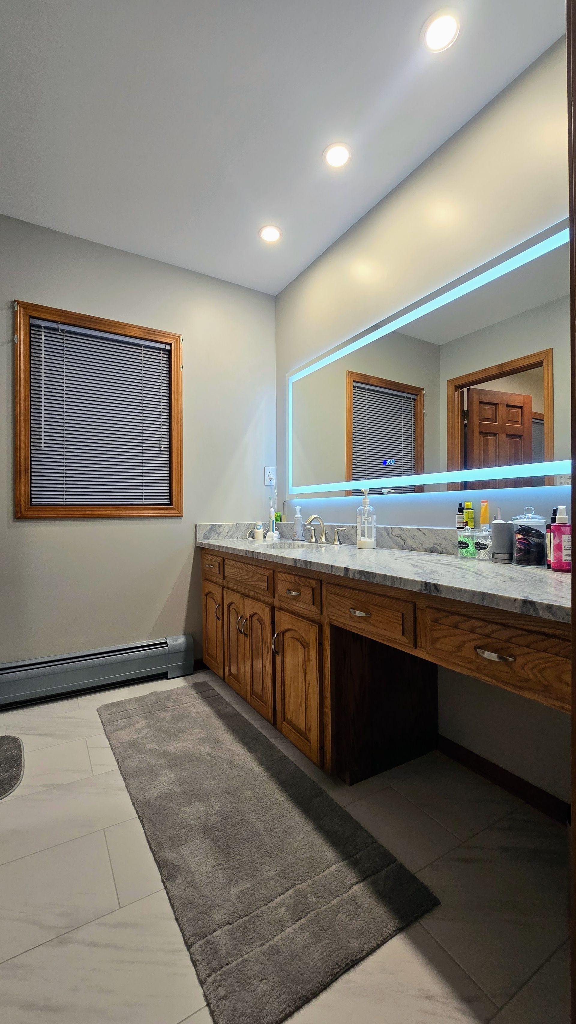 Modern Bristol bathroom vanity with a lighted mirror and black faucets.