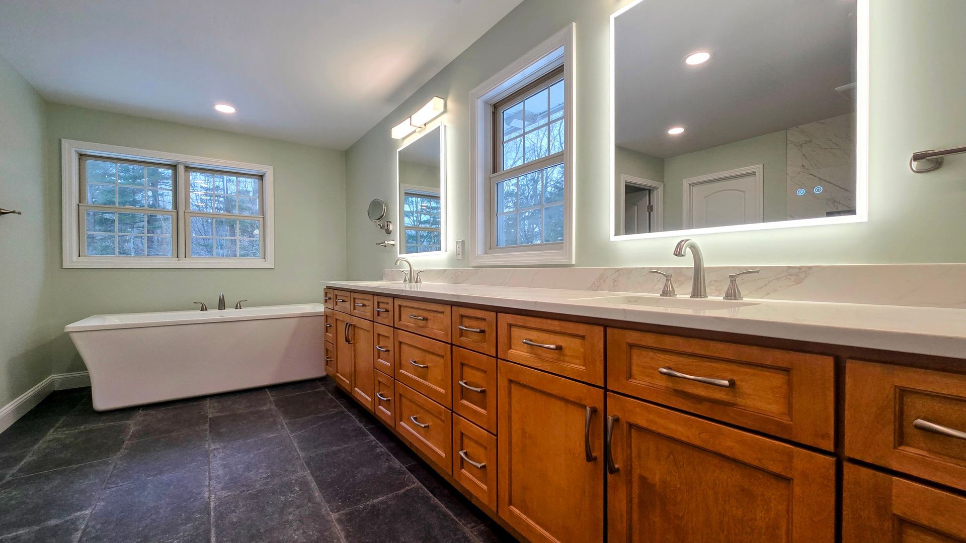 A green and white van with the words `` your dream bathroom awaits '' on it.
