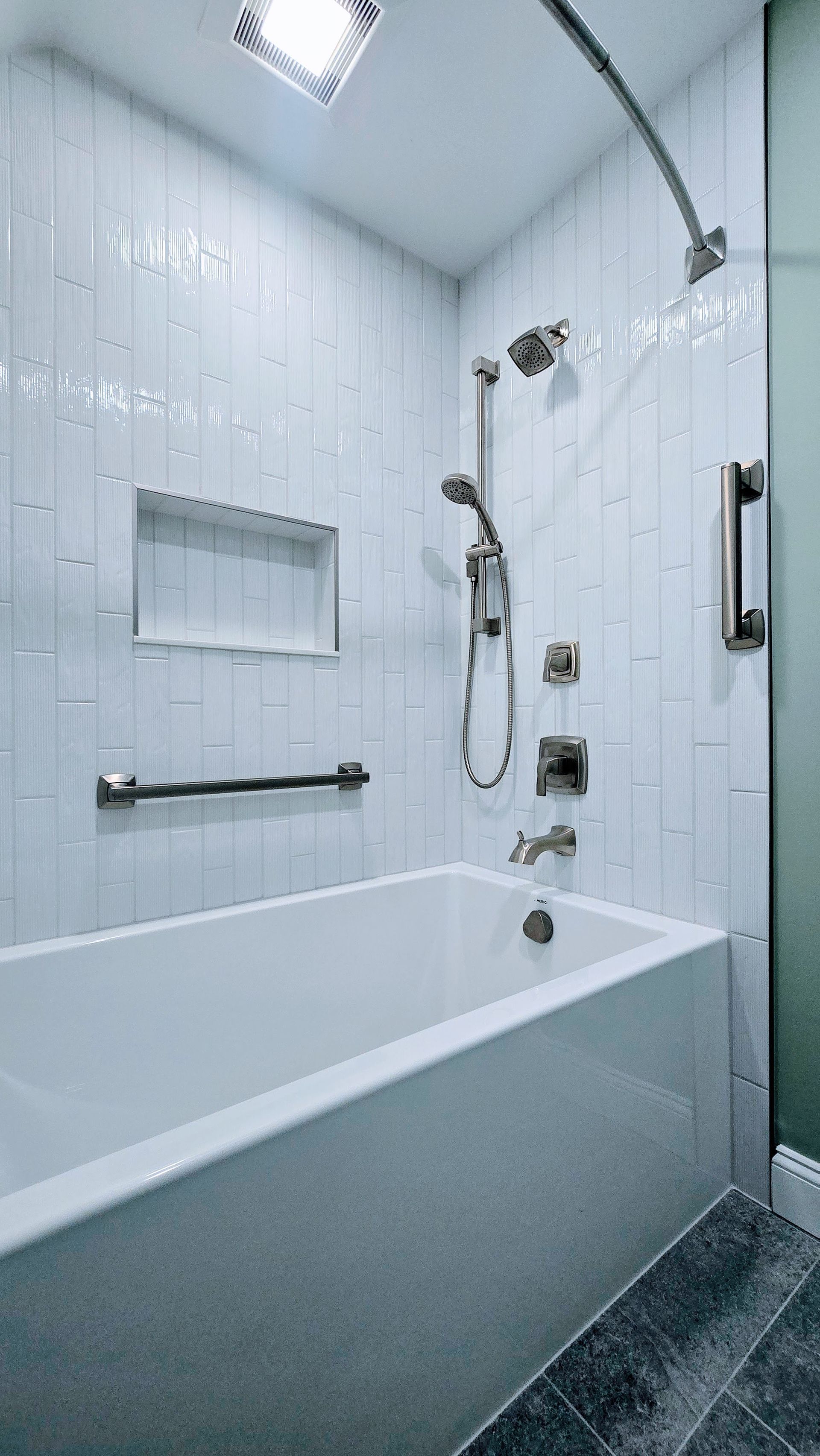 Modern white bathroom in Glastonbury, CT with a tub, shower, and grab bars.