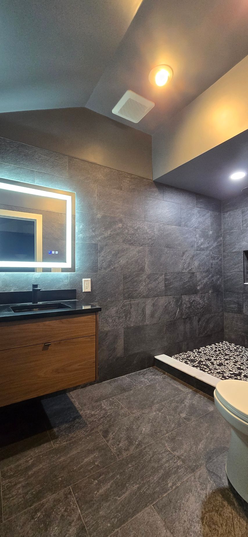 Modern Bristol bathroom vanity with a lighted mirror and black faucets.