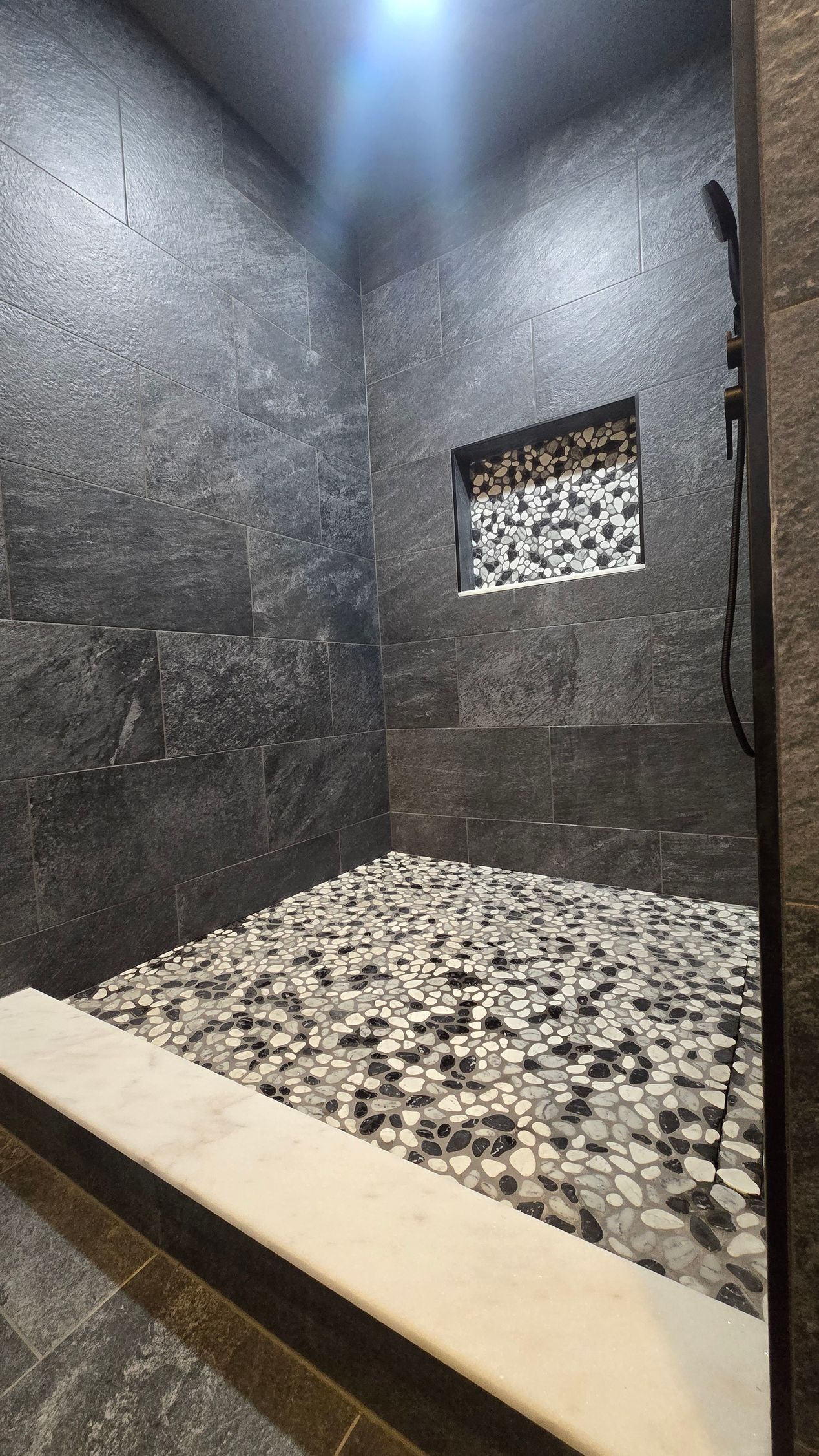 Bristol bathroom vanity with black fixtures, lit mirror, and neutral walls.