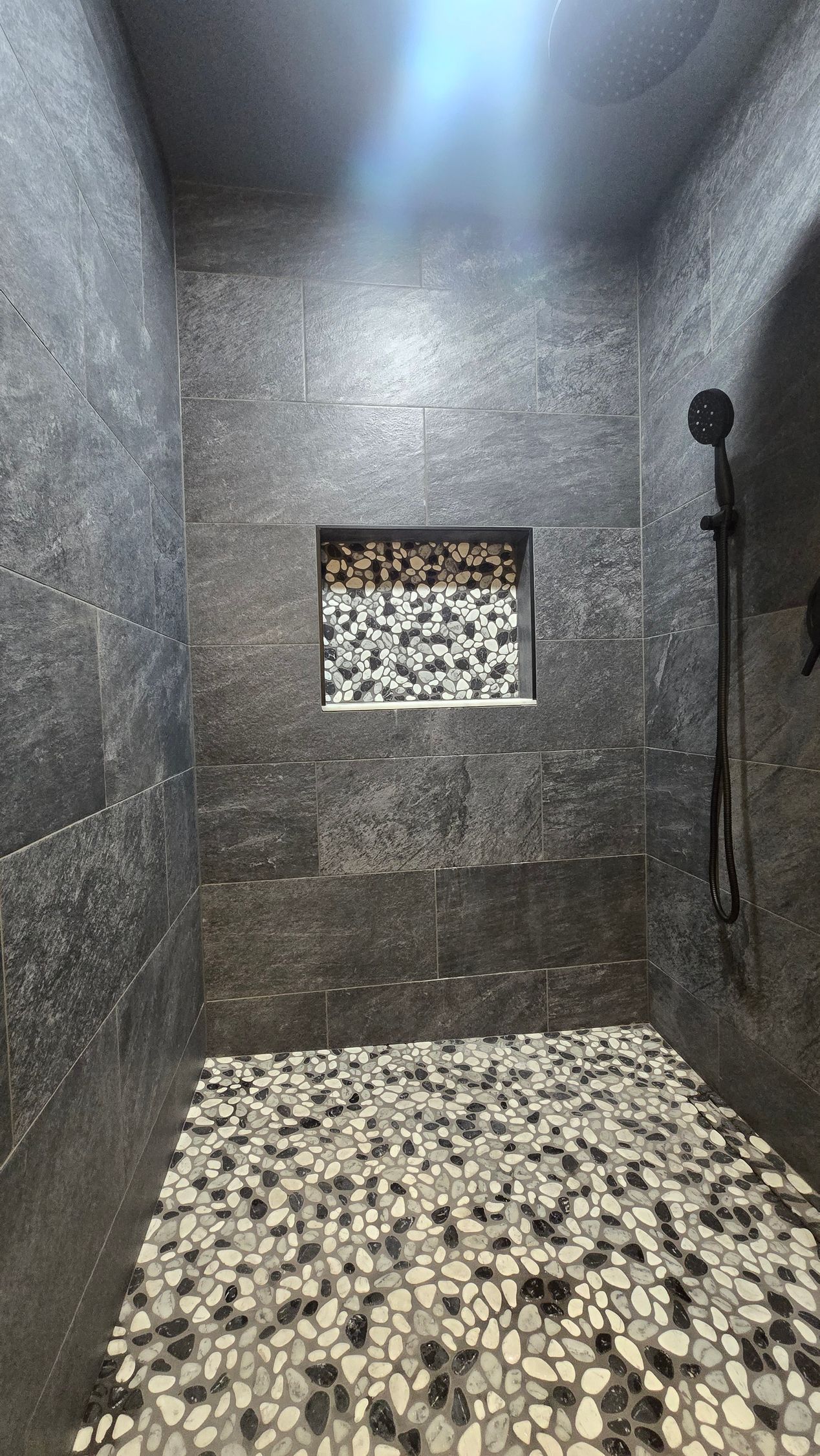 Bristol bathroom with double sinks, large mirror with lightbulbs, and a window.