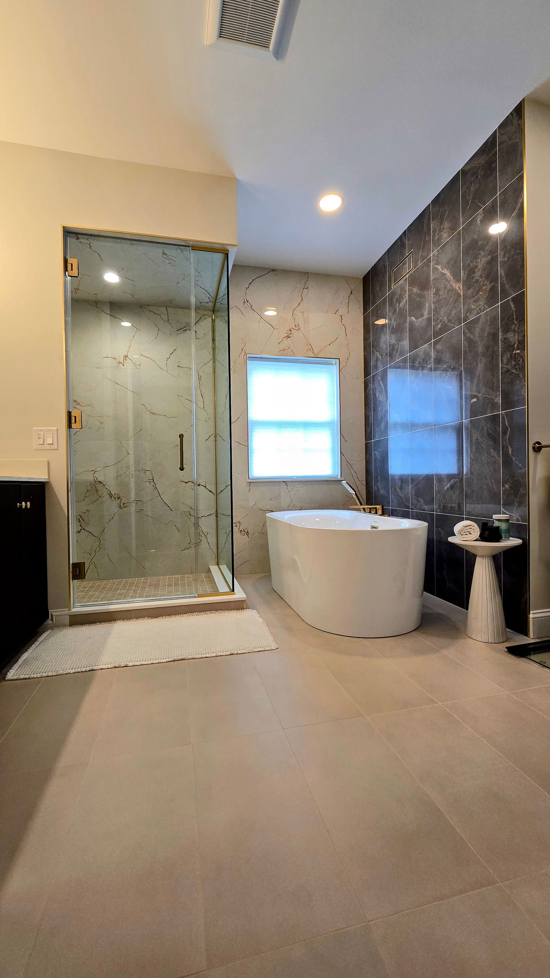 A bathroom vanity with a fluted wooden cabinet, gold fixtures, and two rectangular mirrors on a white wall.