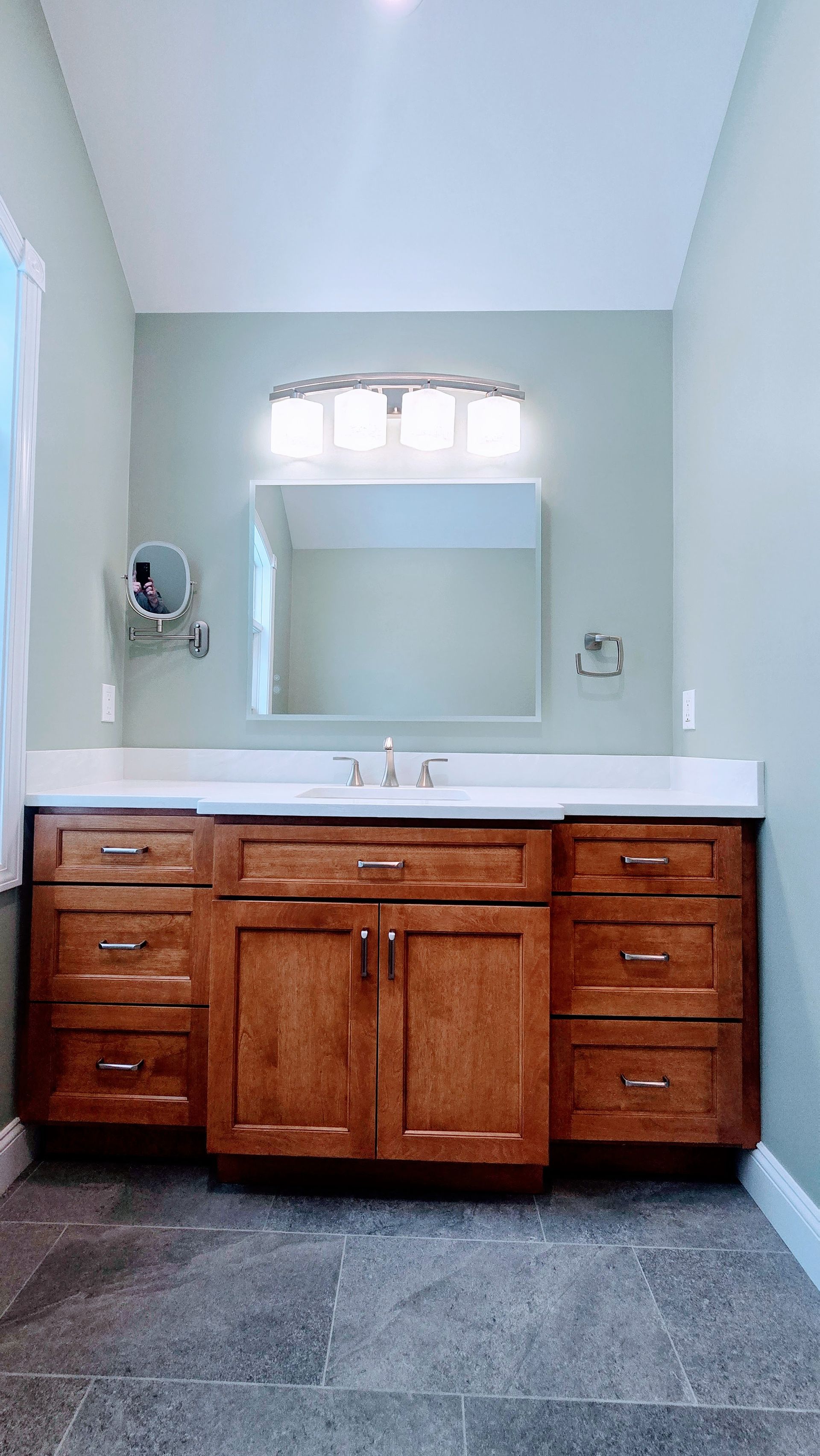 Bristol, CT black shower fixtures in a tiled bathroom; overhead showerhead, hand-held shower, and bathtub.