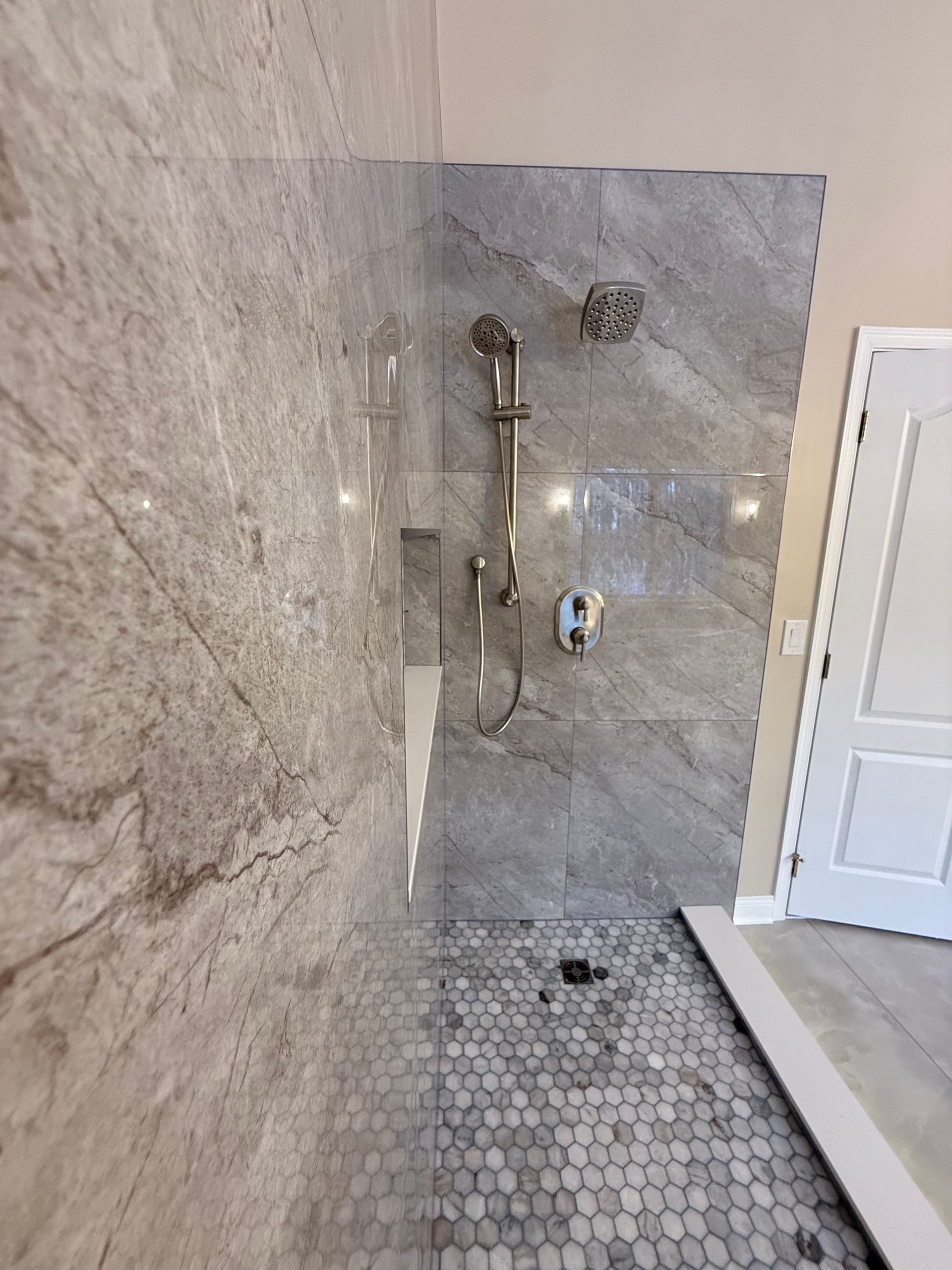 A bathroom with a bathtub and a shower head