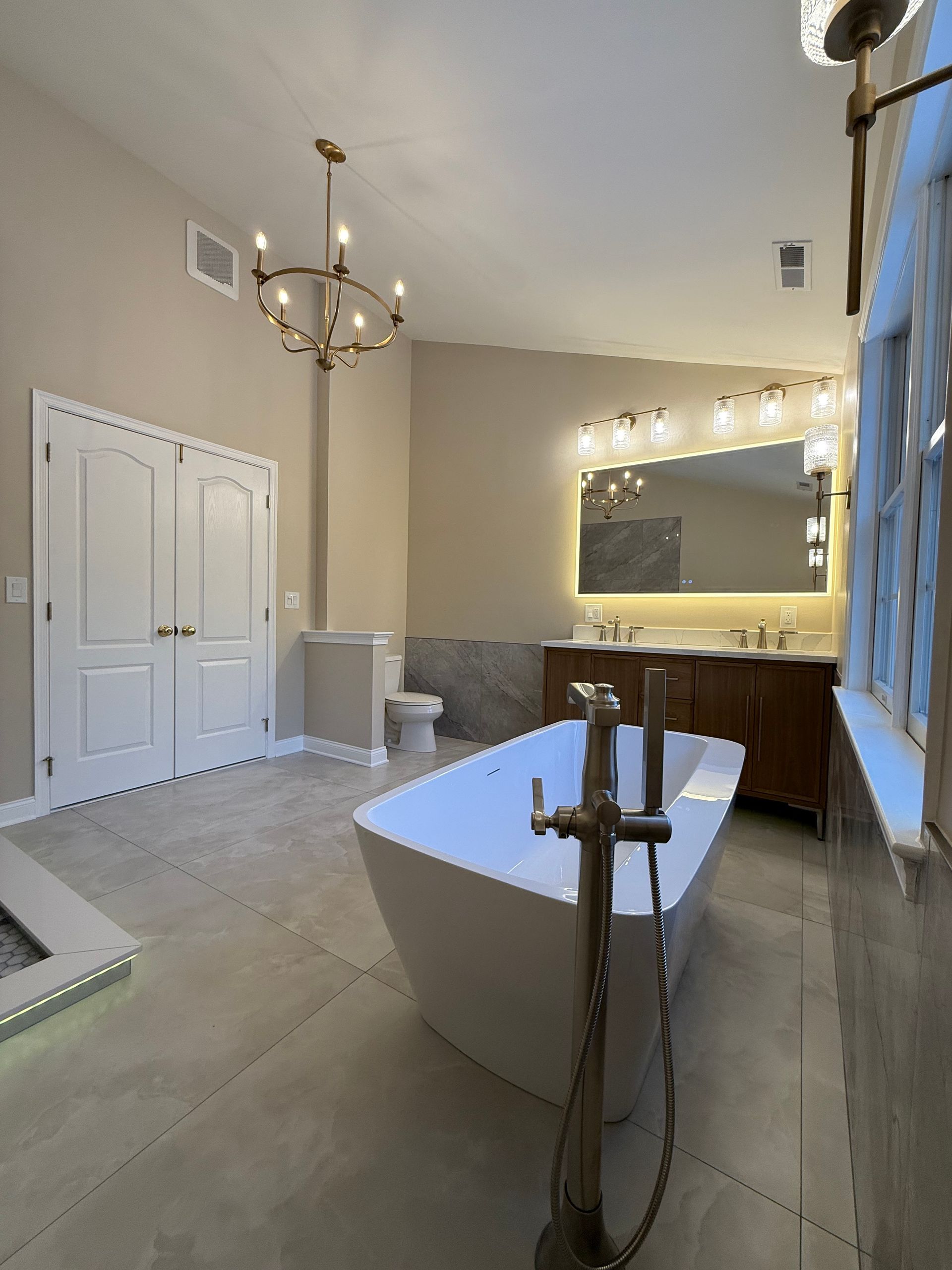 A bathroom with a bathtub and a shower head