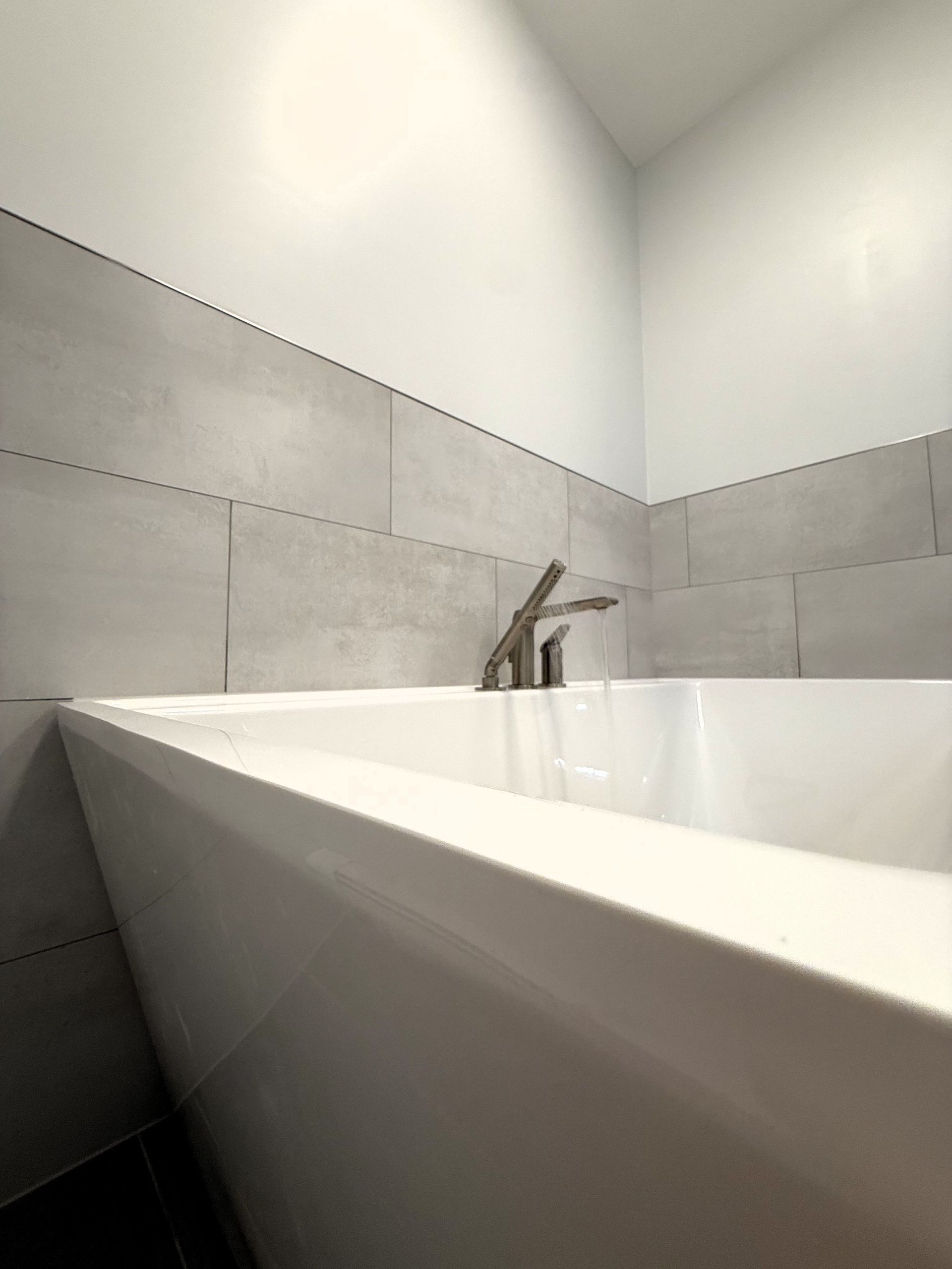 A white bathtub with a faucet in a bathroom.