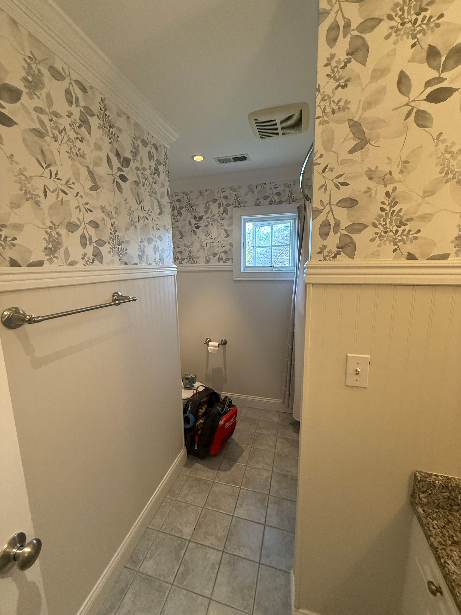 A shower with a built in shelf and a shower head