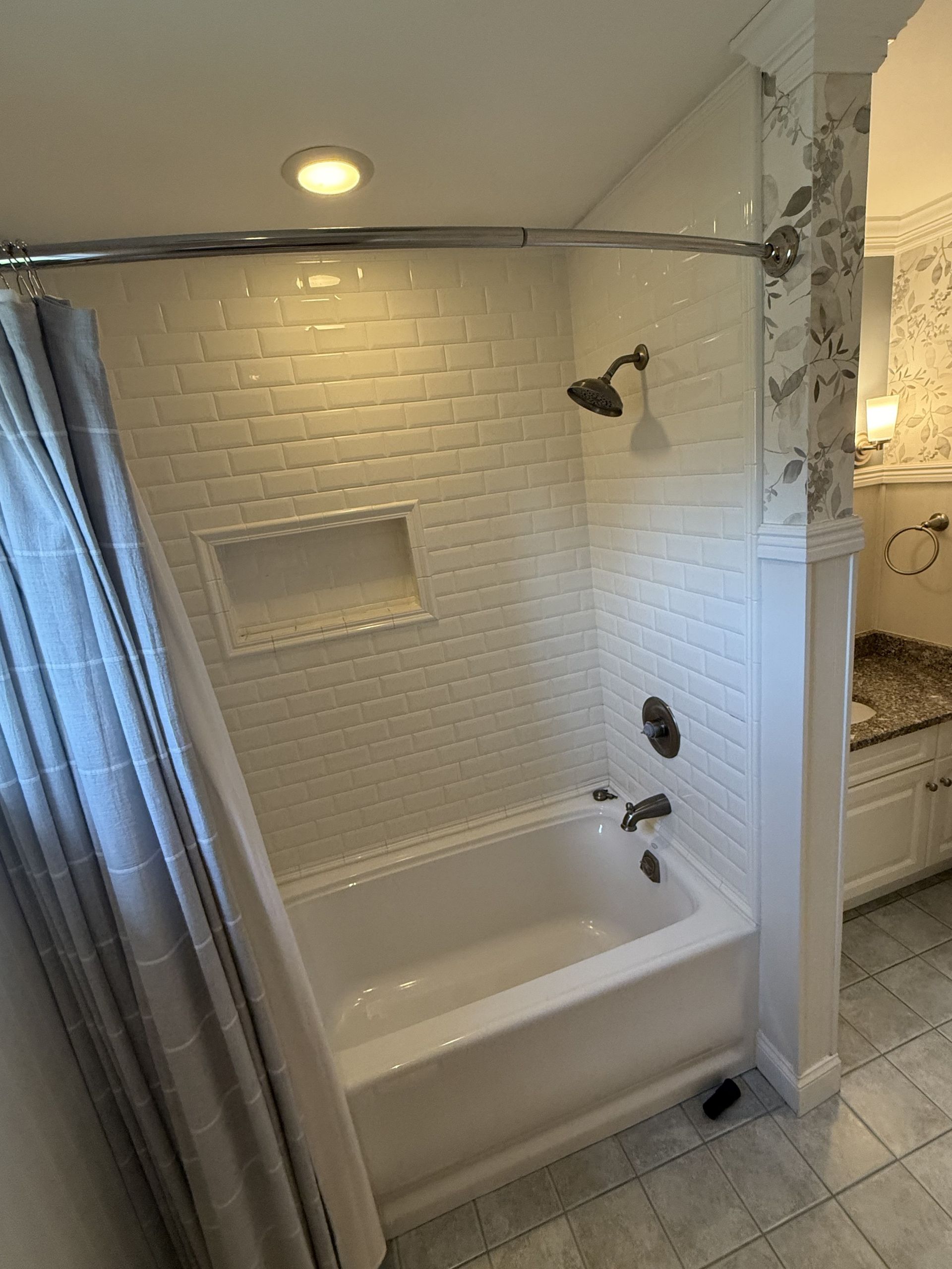 A bathroom with a bathtub and a shower.