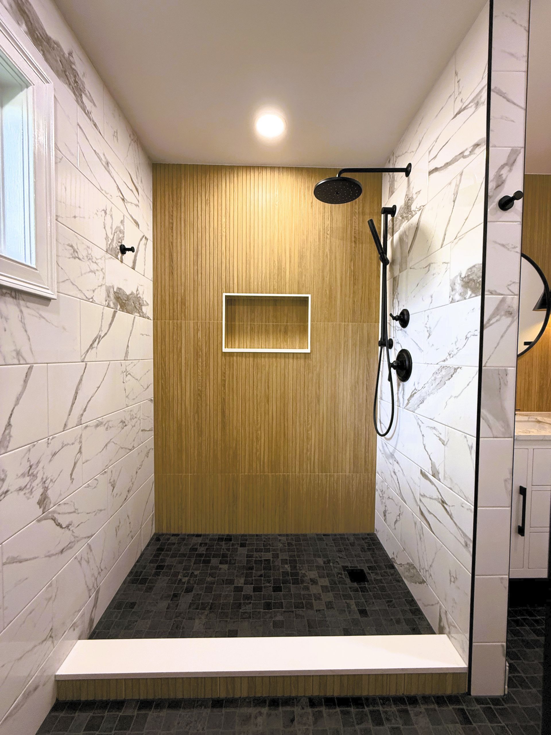 A bathroom with a bathtub and a shower head