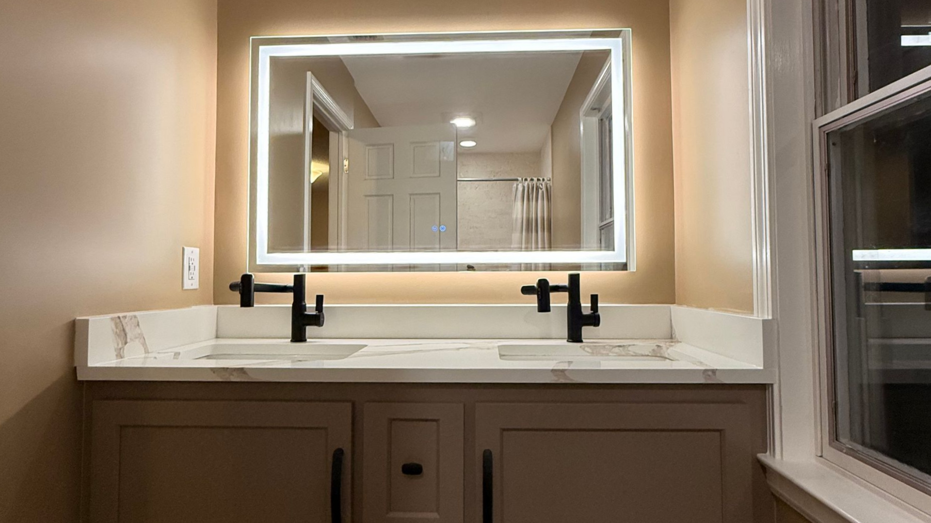 Bathroom with jacuzzi tub, vanity, toilet. Light beige walls, brown cabinets, glass shower door in Wolcott, CT